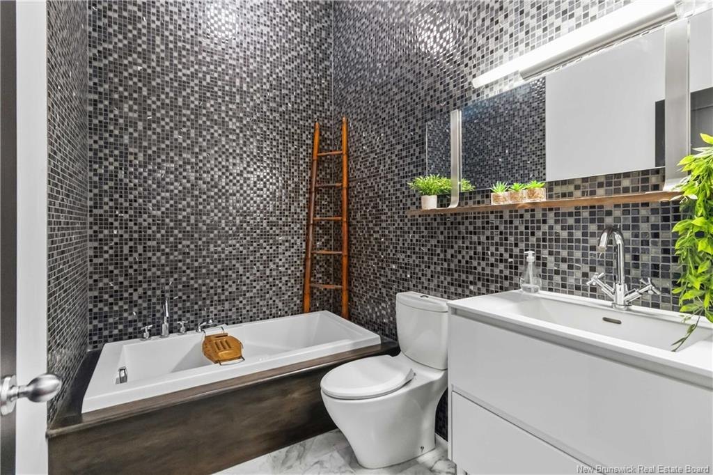 Bathroom with soaker tub and mosaic tile at 303-850 Main Street Moncton