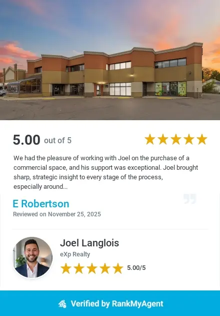 Commercial retail building with large parking lot at sunset. Real estate client review for commercial purchase with Joel Langlois, Realtor in Moncton, rated five stars.