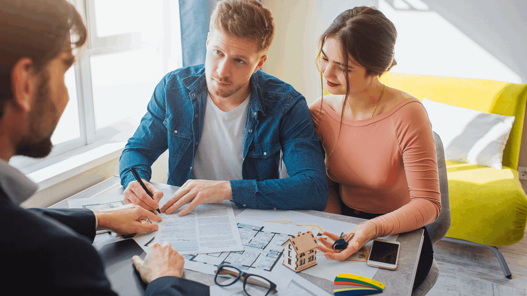 Buyers meeting with an agent to review strategy and documents