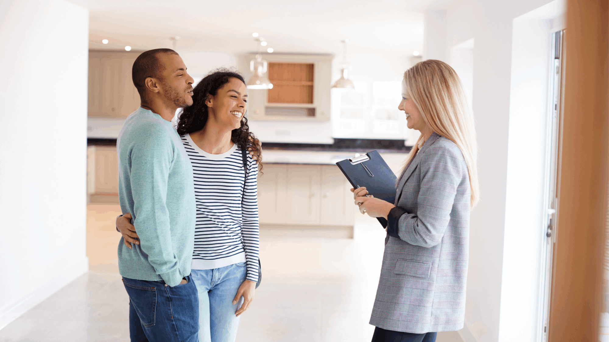 Home buyers touring a home with an agent