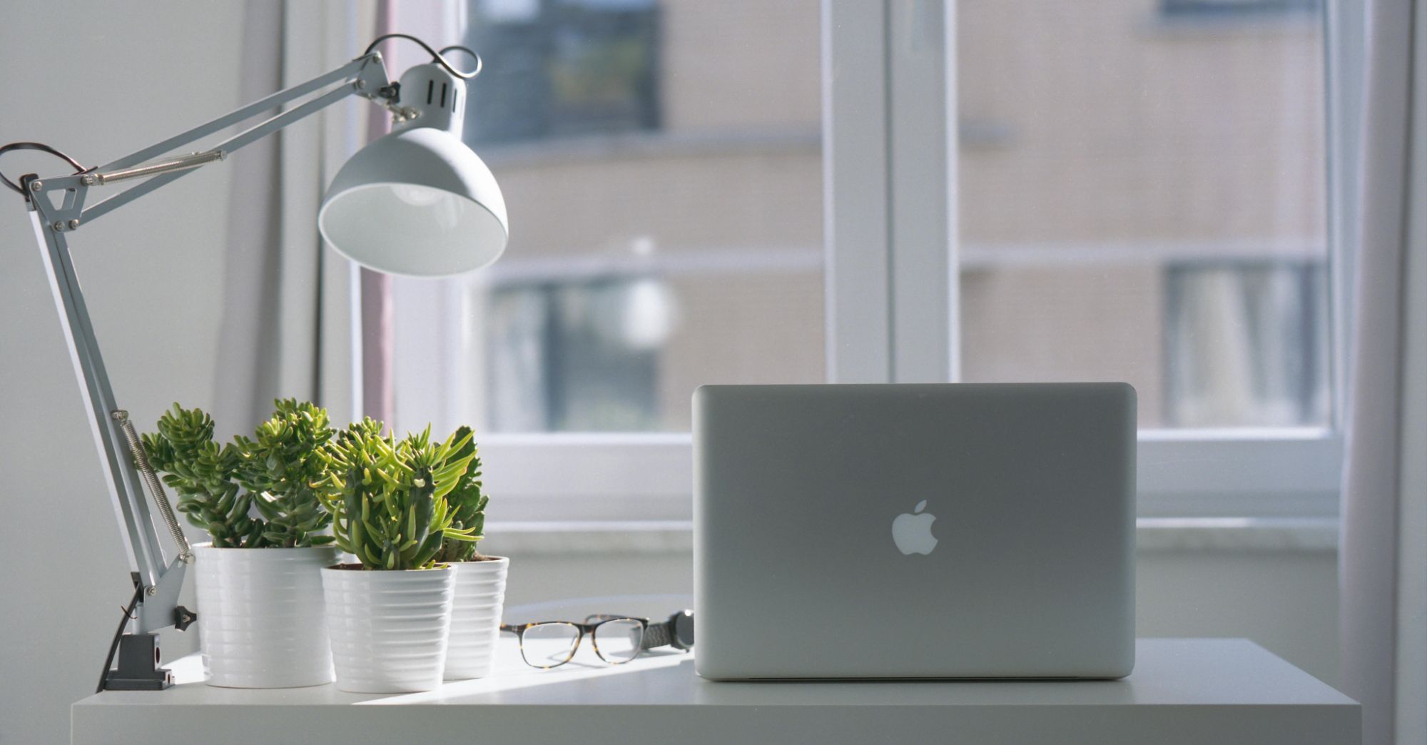 Clean white desk, Houston market report printouts, and a phone with a follow-up checklist open