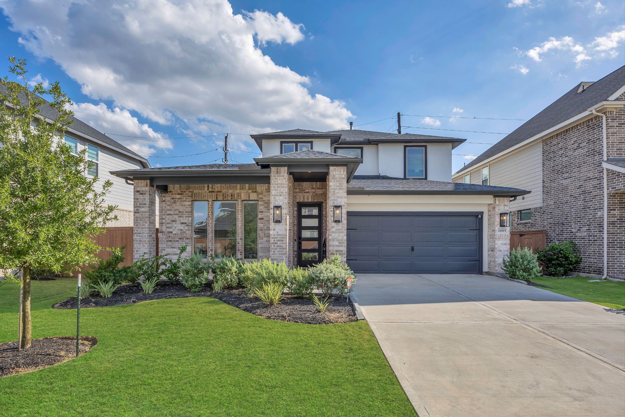 Aerial of a Houston-area subdivision with tree-lined streets, illustrating micro-market variations