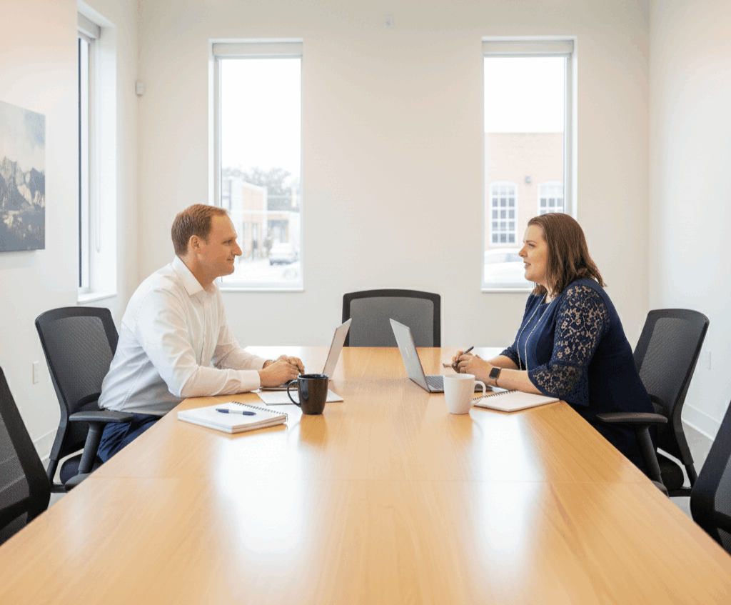 Lumen transaction managers collaborating over contracts and timelines in a modern Houston office