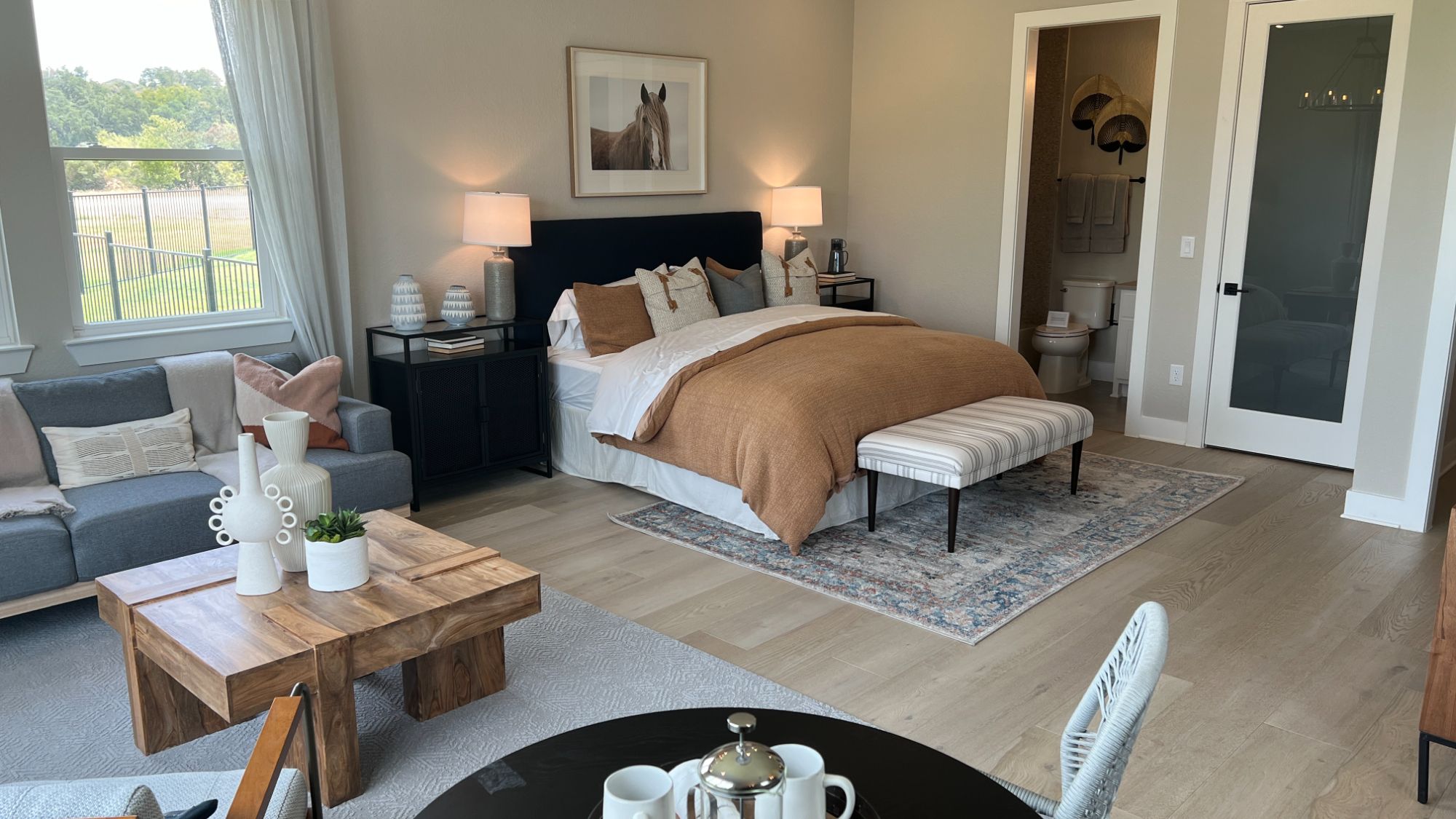 En suite bedroom with private bathroom inside the Blanton model home at Regency at Santa Rita Ranch in Liberty Hill Texas