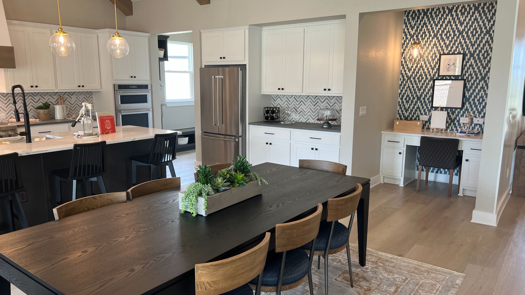 Dining area with built-in desk space inside the Blanton model home at Regency at Santa Rita Ranch in Liberty Hill Texas