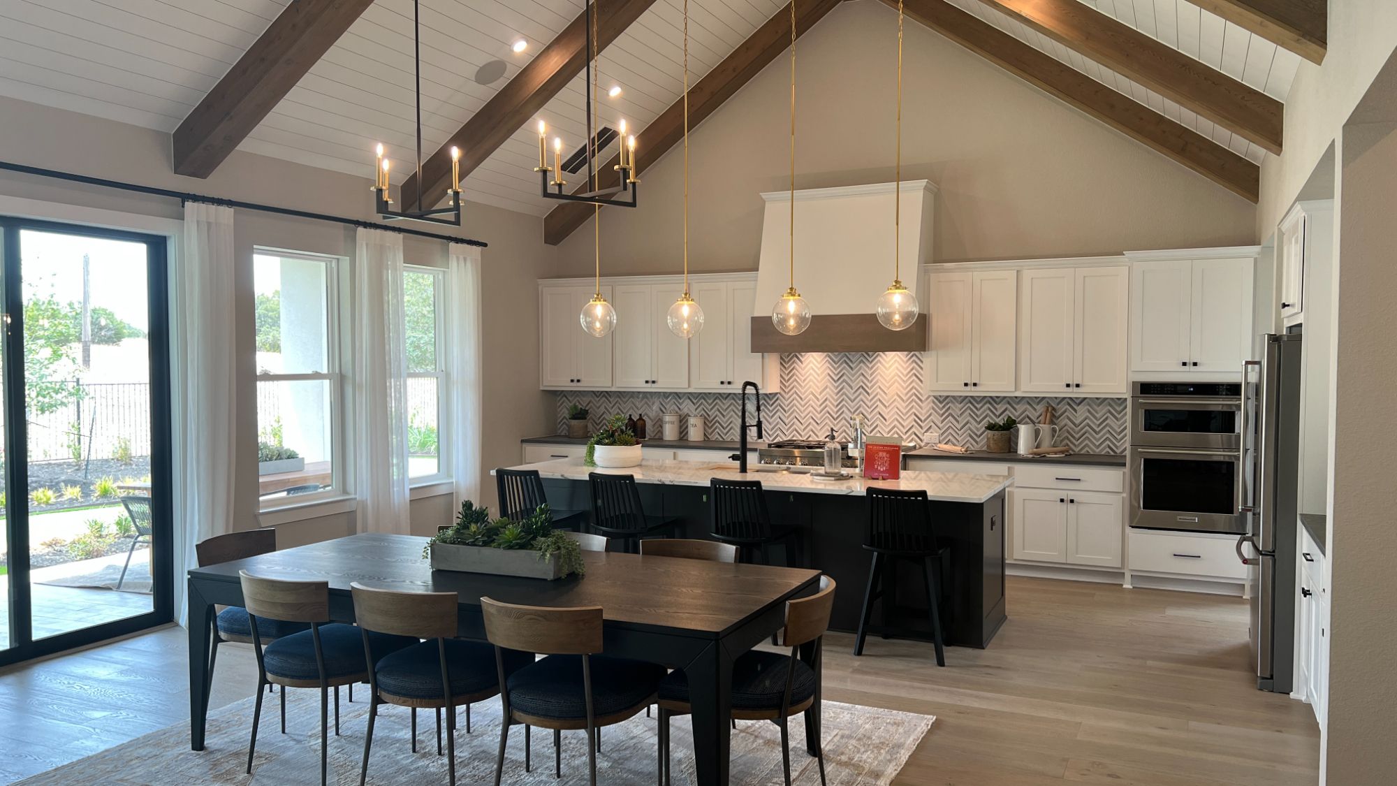 Dining area and kitchen inside the Blanton model home at Regency at Santa Rita Ranch in Liberty Hill Texas