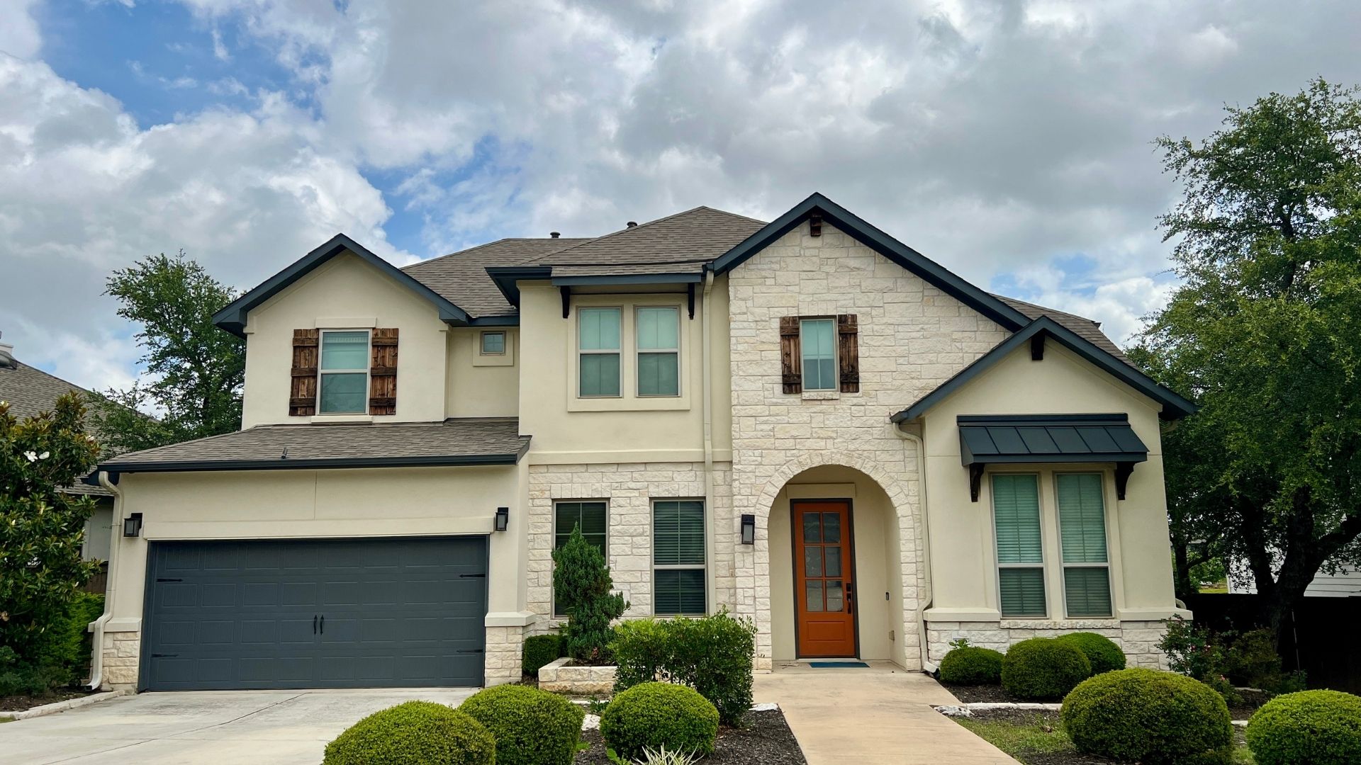 Larger home in the Bryson master-planned community in Leander Texas with modern exterior design and landscaped front yard