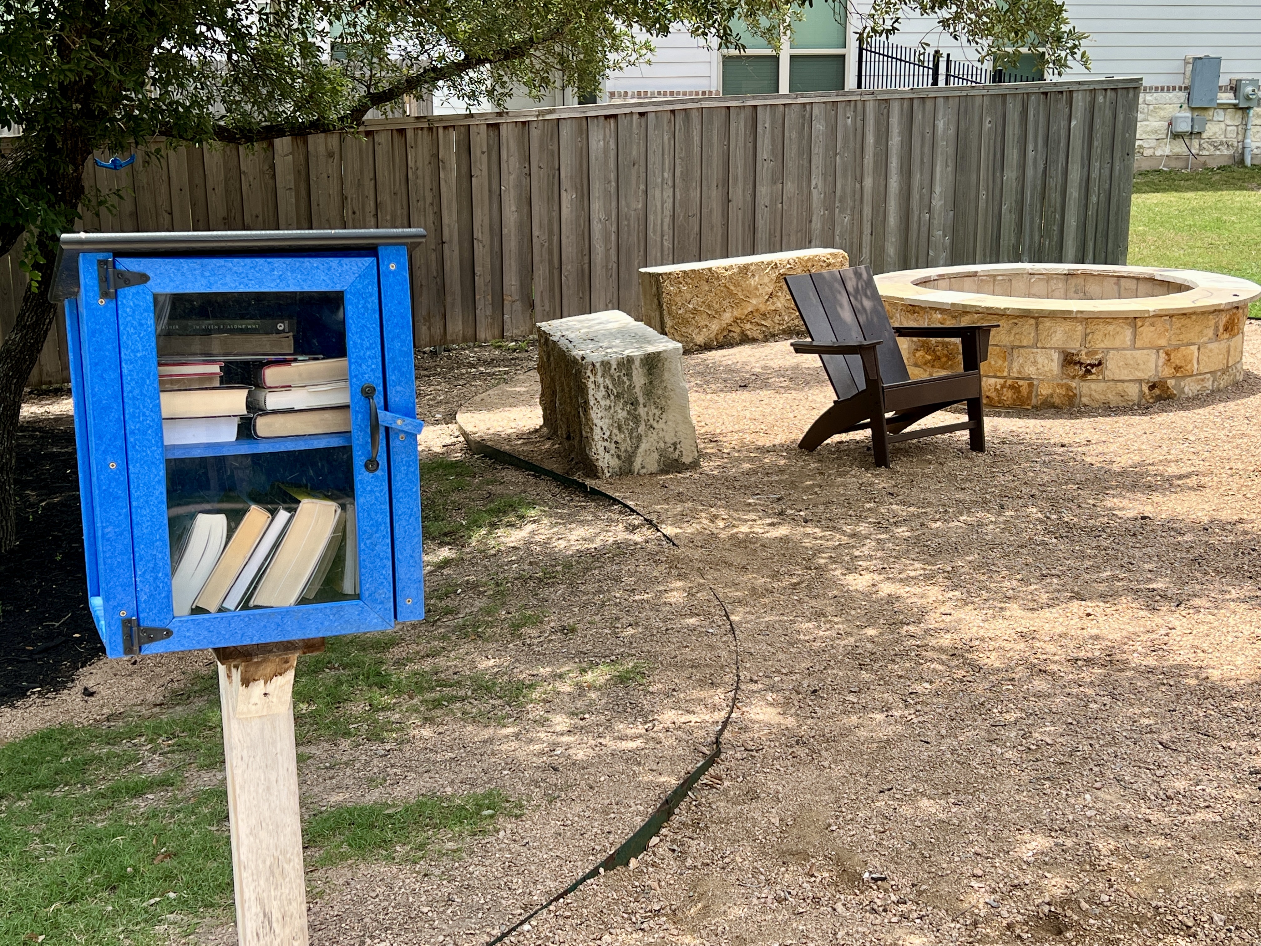 Little library and fire pit at Larkspur in Leander TX, part of the neighborhood amenity center and community gathering spaces