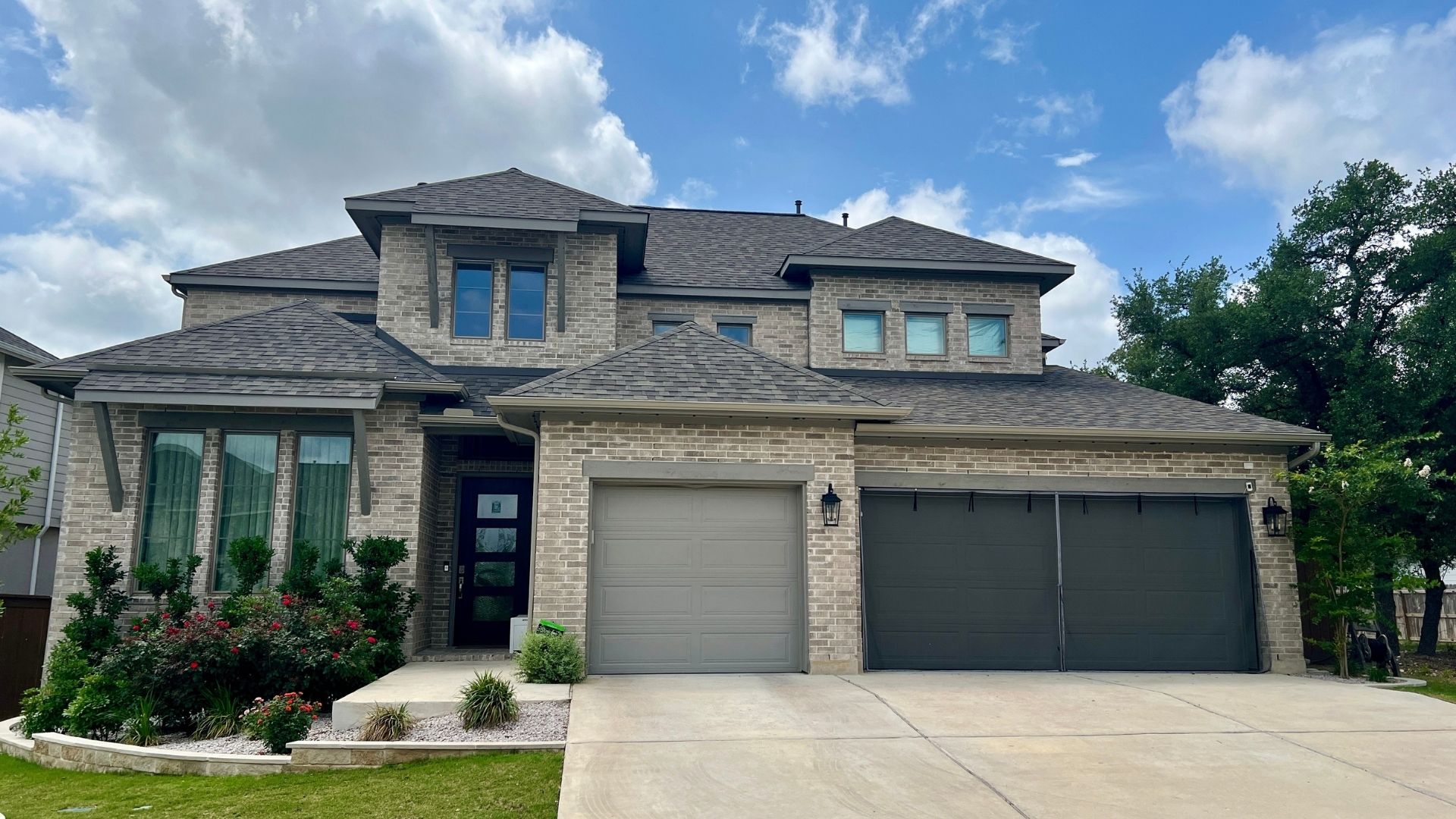 Bryson Leander TX home exterior with covered front porch and landscaped entry