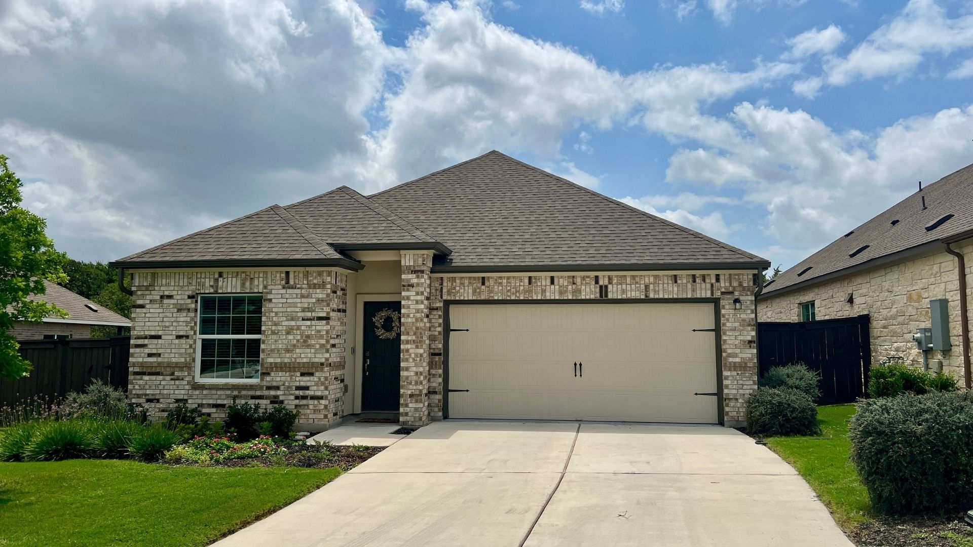Smaller home in the Bryson master-planned community in Leander Texas with modern suburban design and landscaped front yard