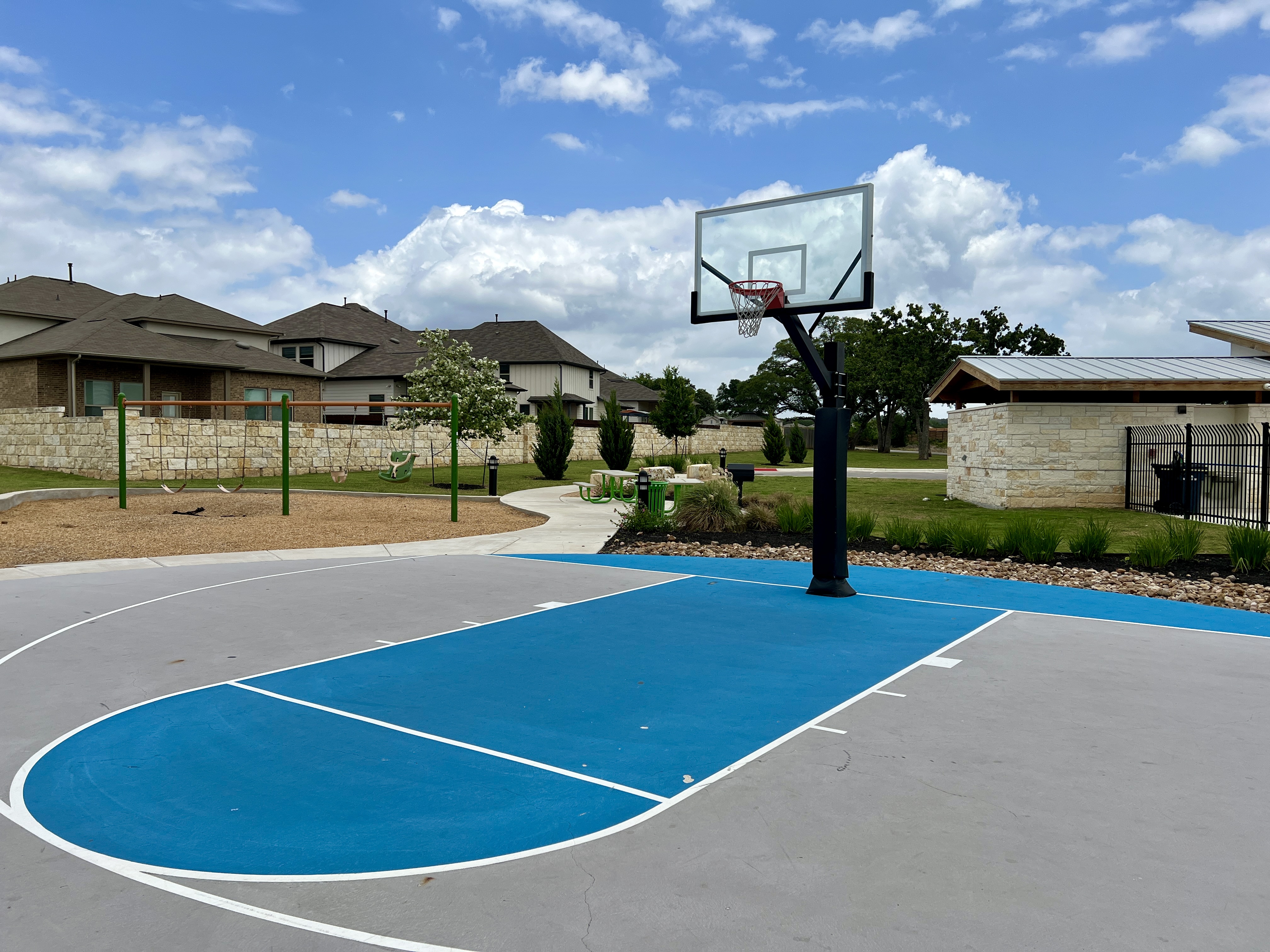 Community basketball court at Larkspur in Leander TX, part of the recreational amenities in this master-planned neighborhood