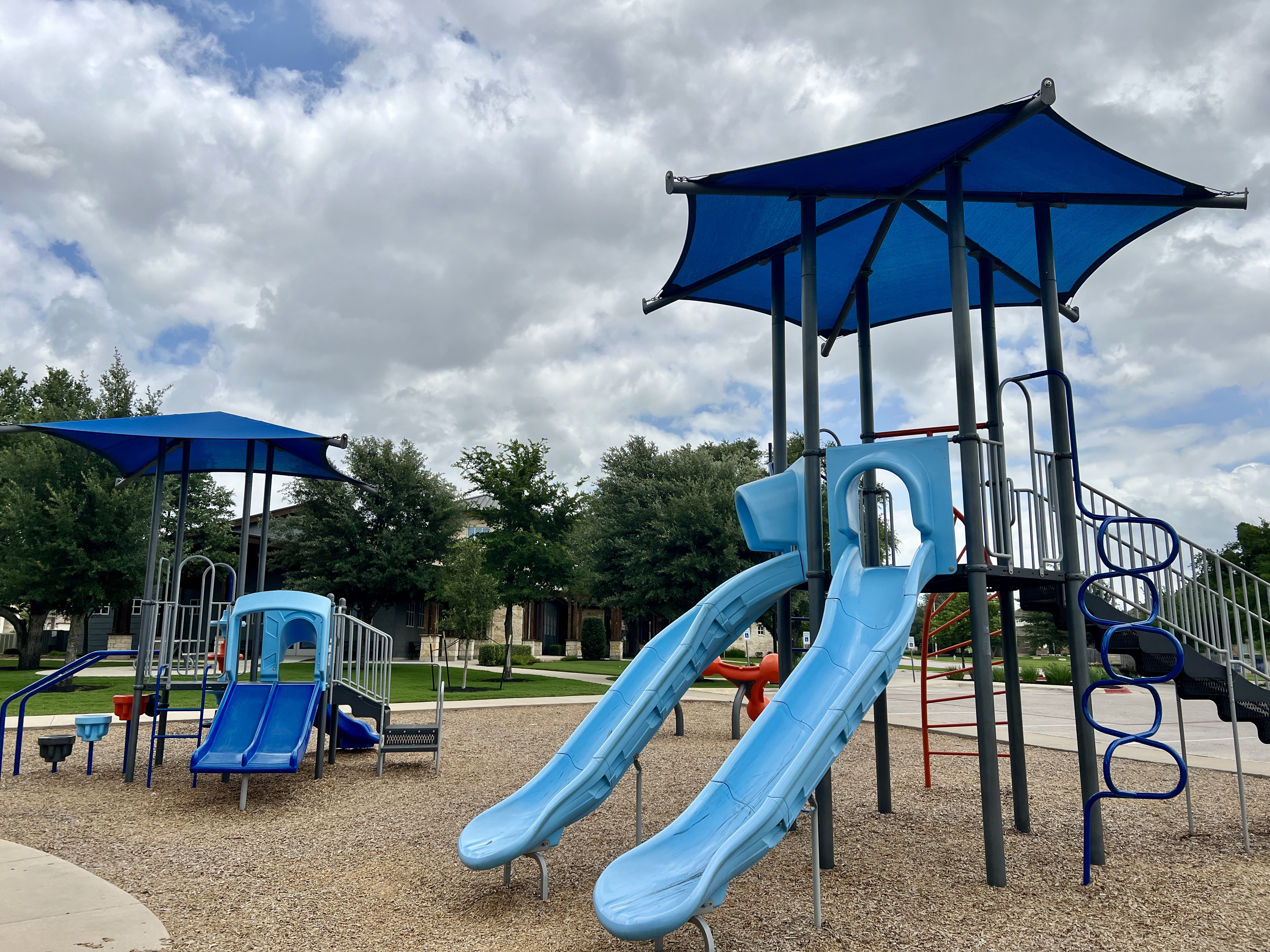Playground at the Larkspur amenity center in Leander Texas with shaded play space and neighborhood amenities for families