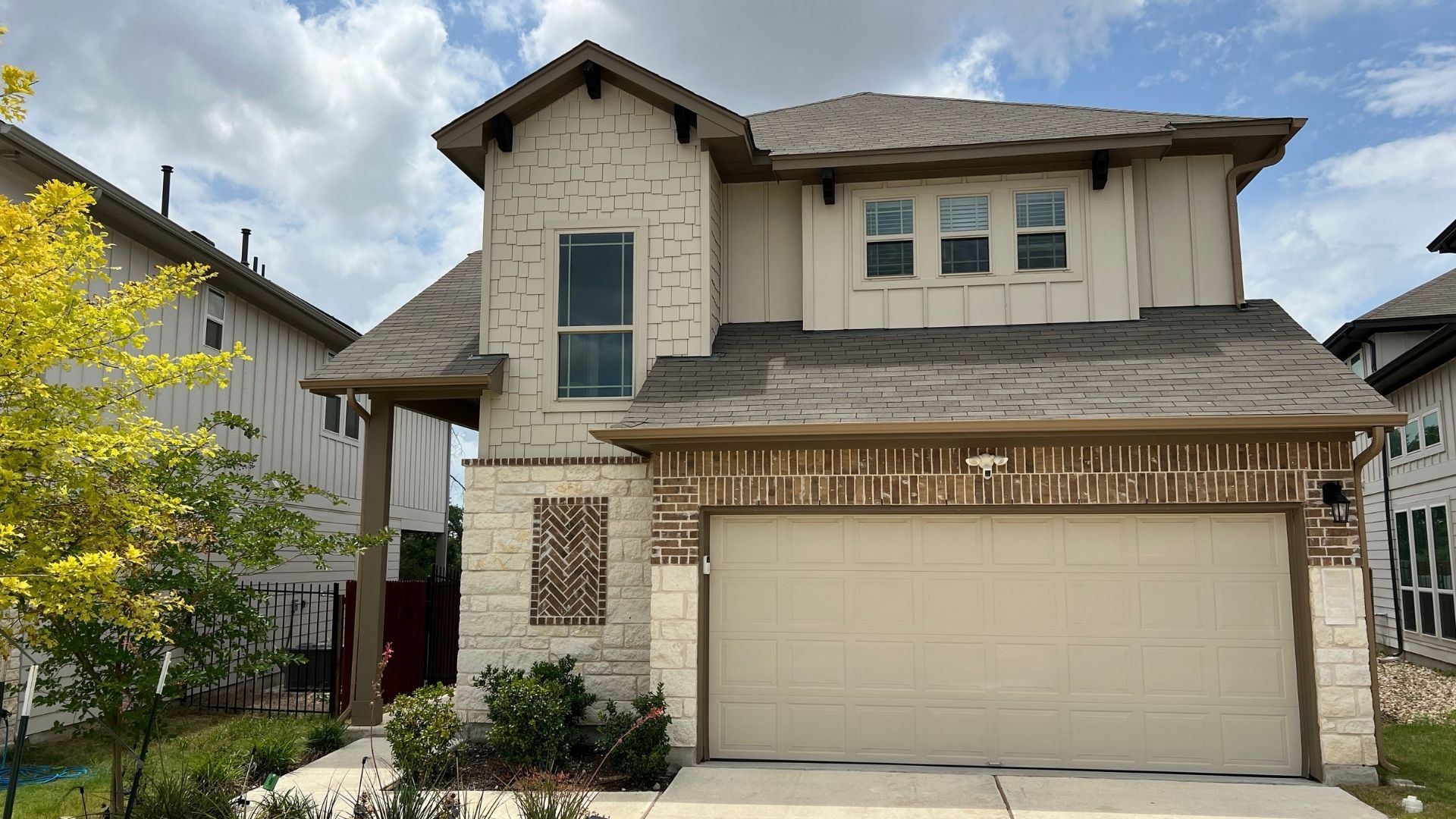 Larkspur home exterior in Leander Texas with attached garage and neighborhood landscaping