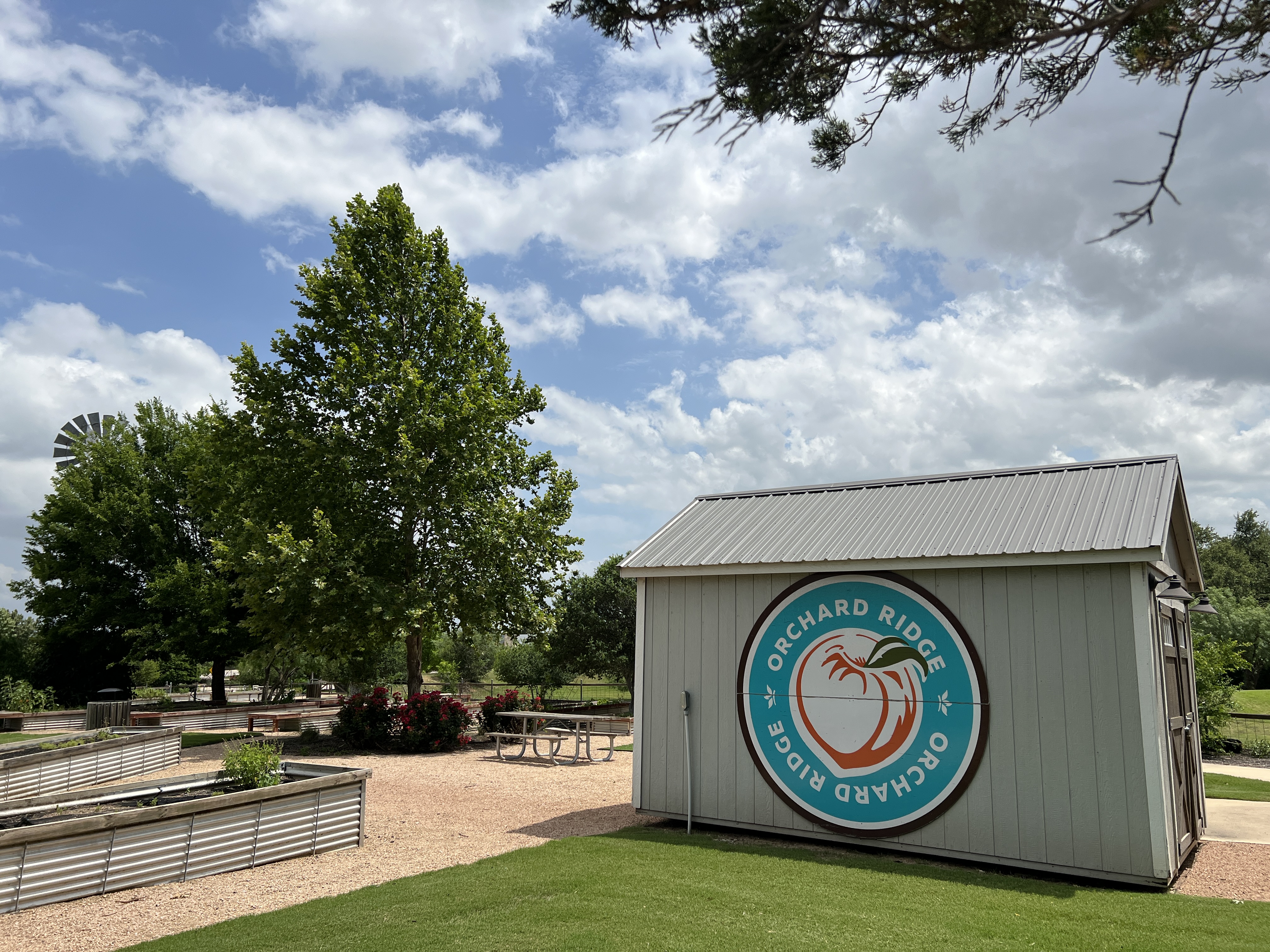 Orchard Ridge Founders Garden in Liberty Hill Texas with raised garden beds, community gathering space, and neighborhood landscaping