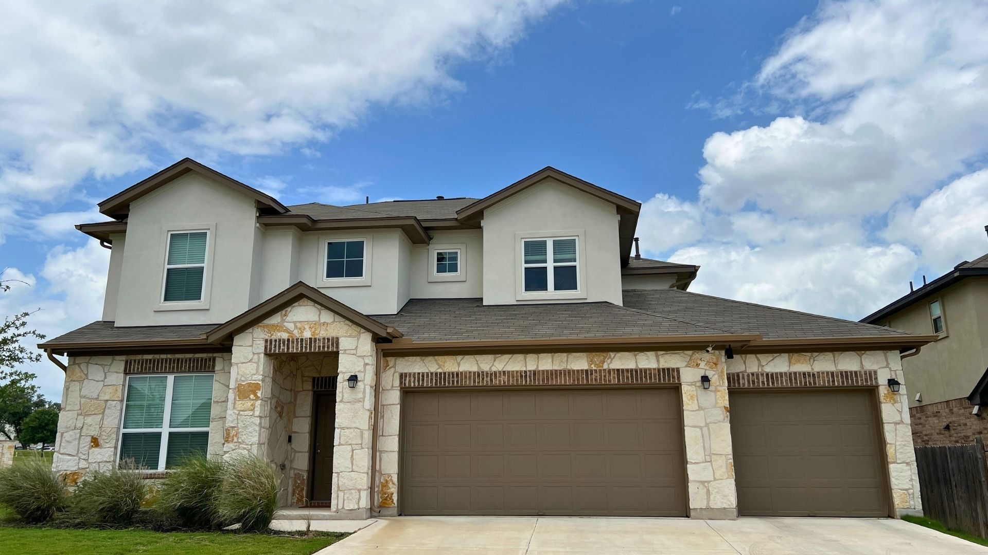 Larkspur Leander TX home exterior with attached garage and established neighborhood setting
