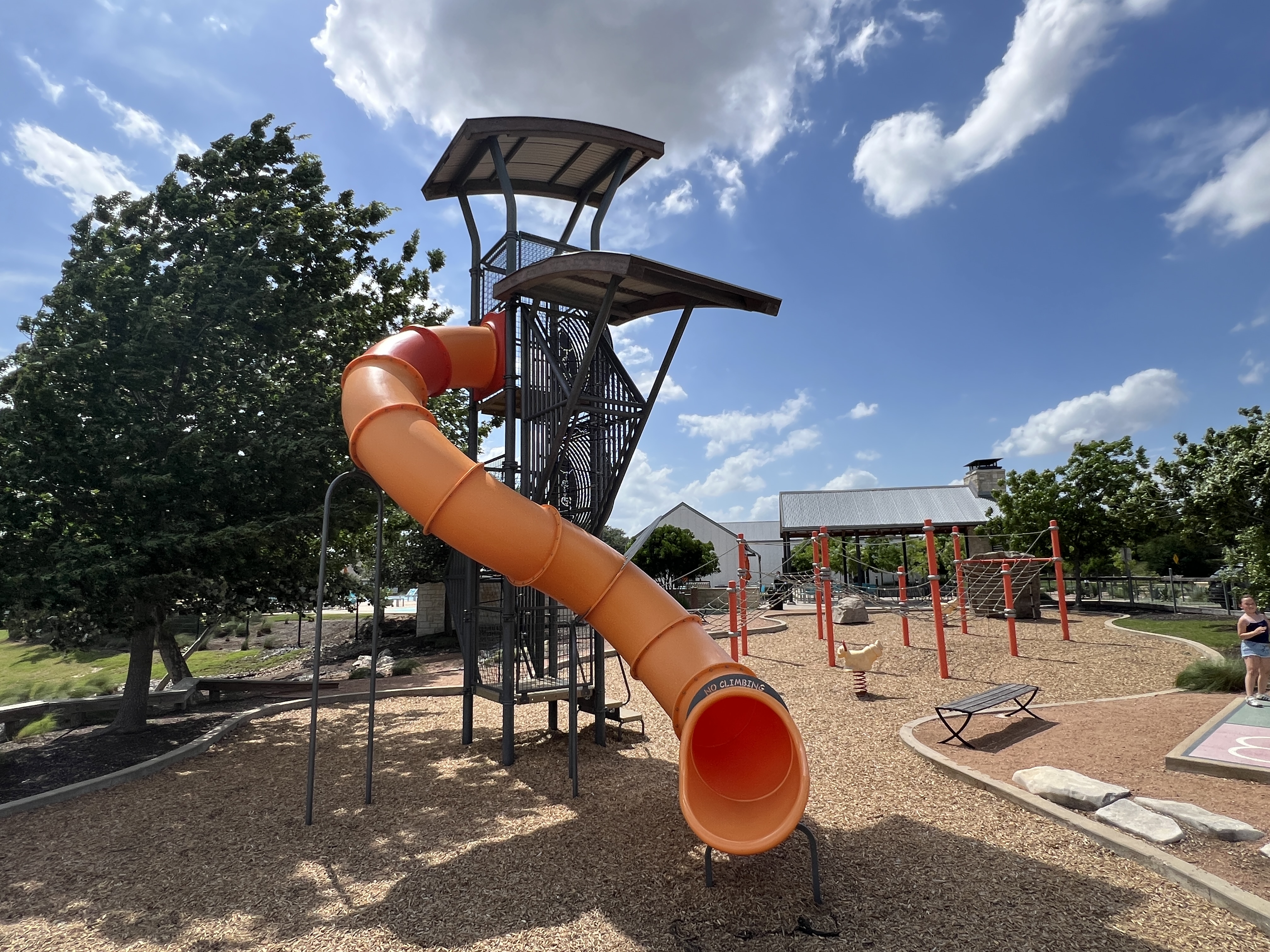 Playground and adventure play area at Orchard Ridge Liberty Hill Texas with large tube slide and family-friendly community amenities