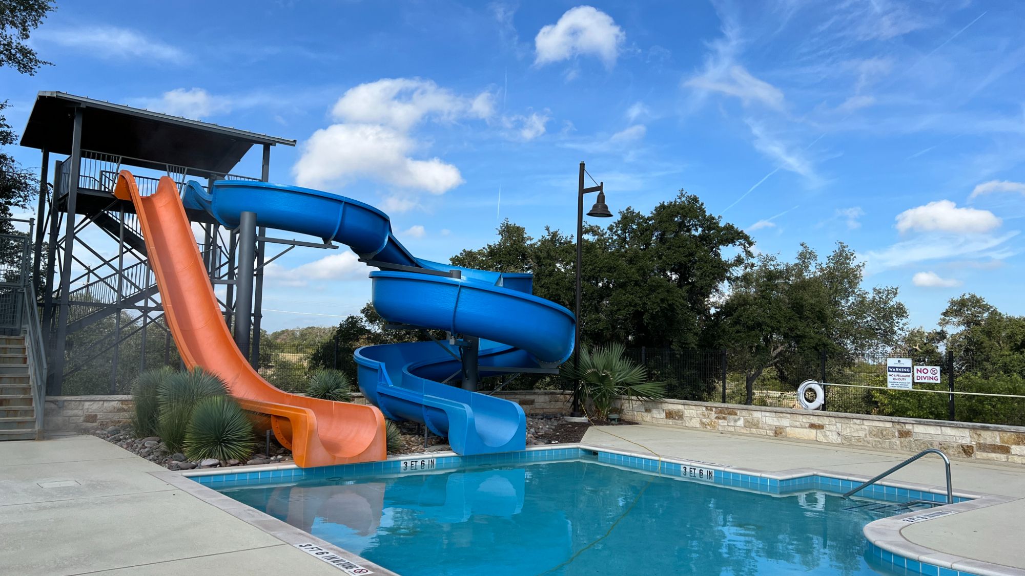 Water slides and resort-style pool at The Ranch House in Santa Rita Ranch Liberty Hill Texas