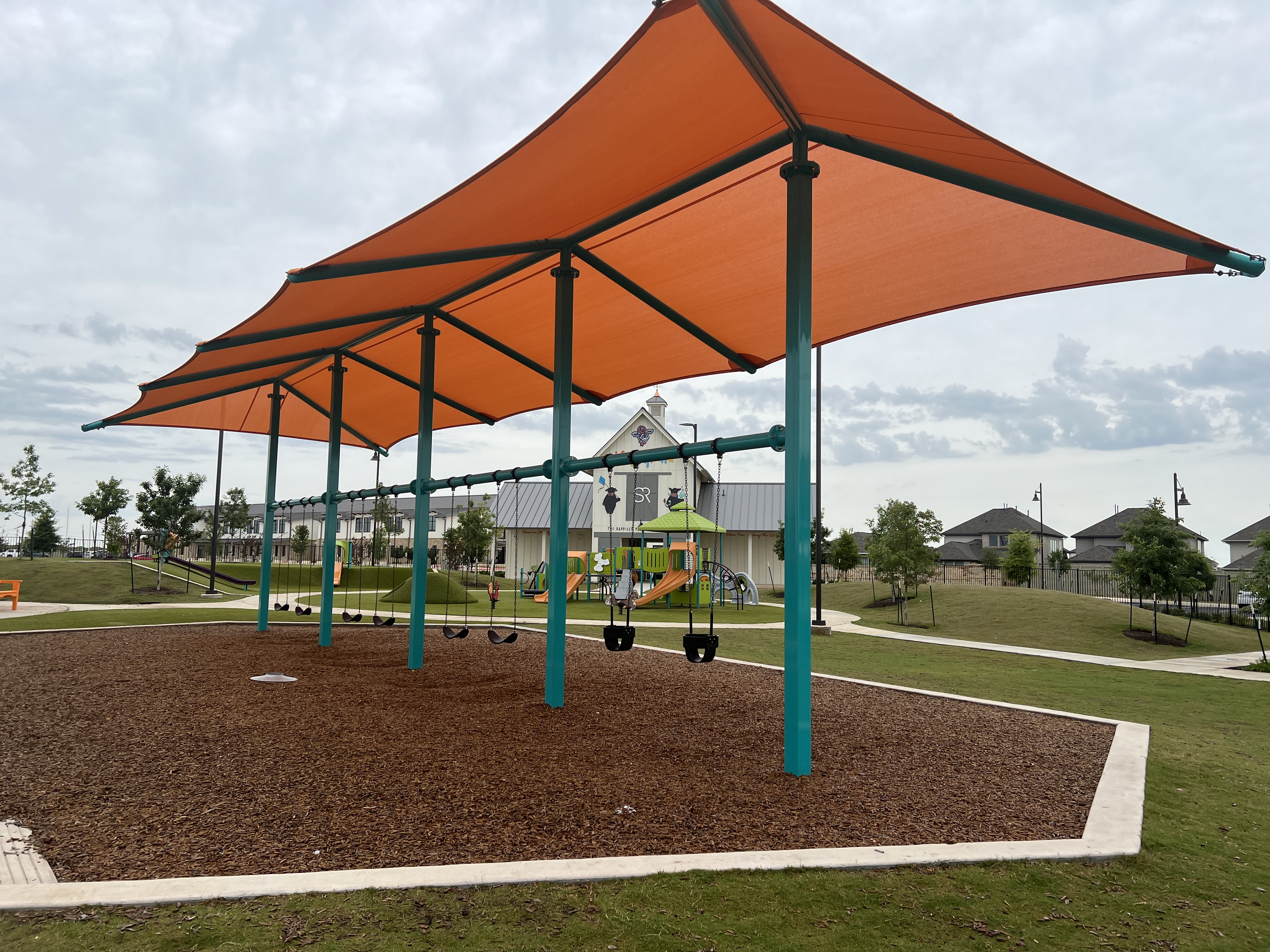 Happyland playground swings at Santa Rita Ranch in Liberty Hill Texas
