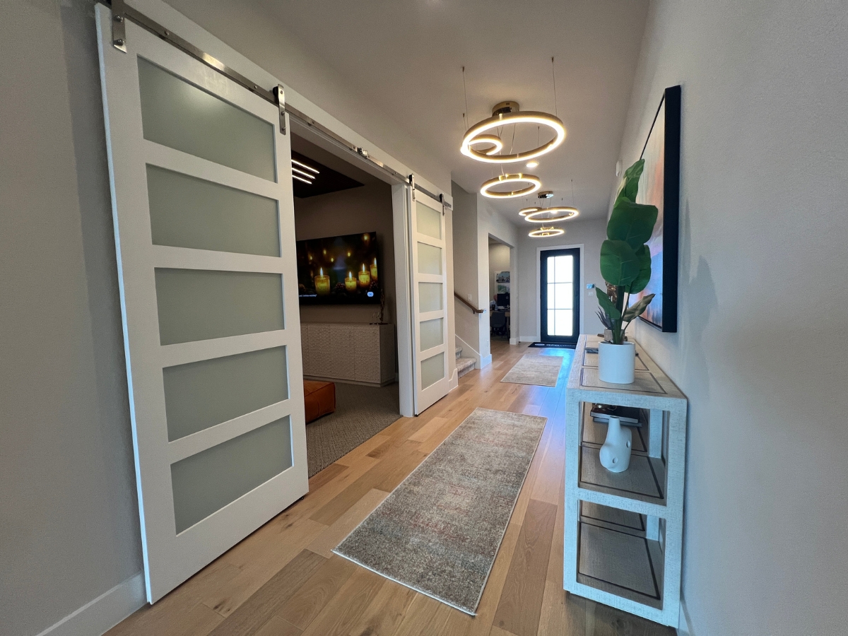 GFO entryway with barn doors leading to media room in Saddleback at Santa Rita Ranch Liberty Hill Texas