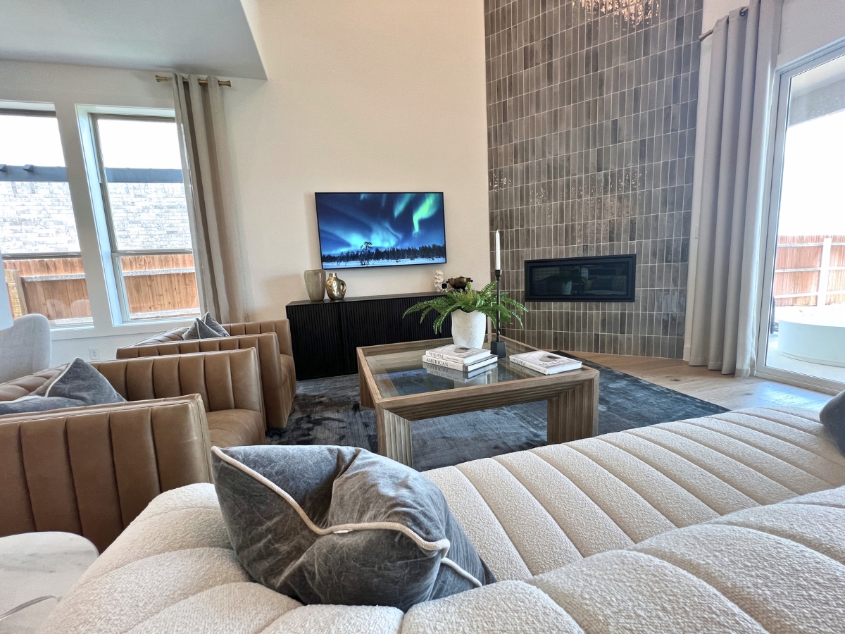Pulte living room with fireplace in Saddleback at Santa Rita Ranch Liberty Hill Texas