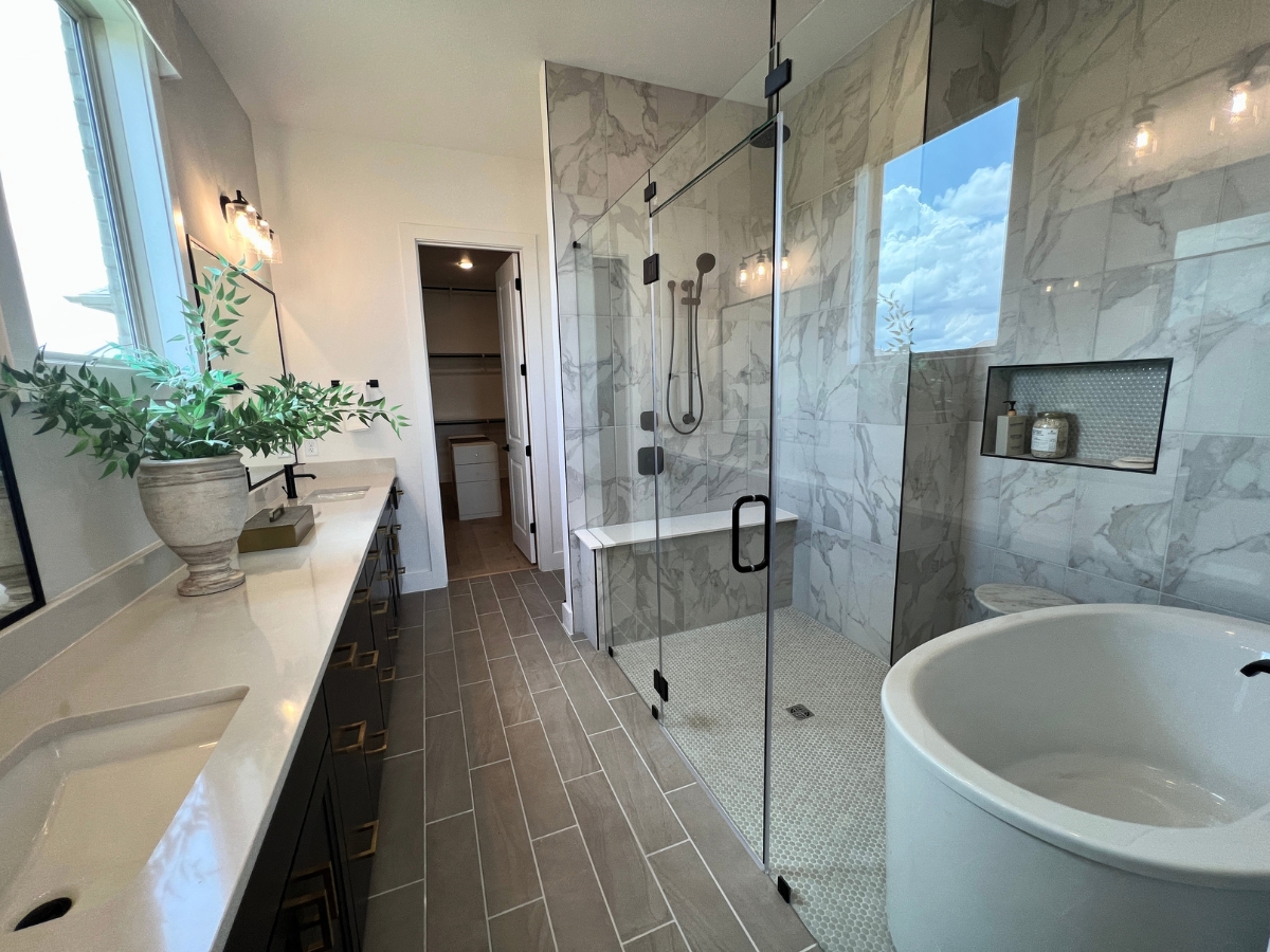 Pulte primary bathroom with soaking tub and walk-in shower in Saddleback at Santa Rita Ranch Liberty Hill Texas