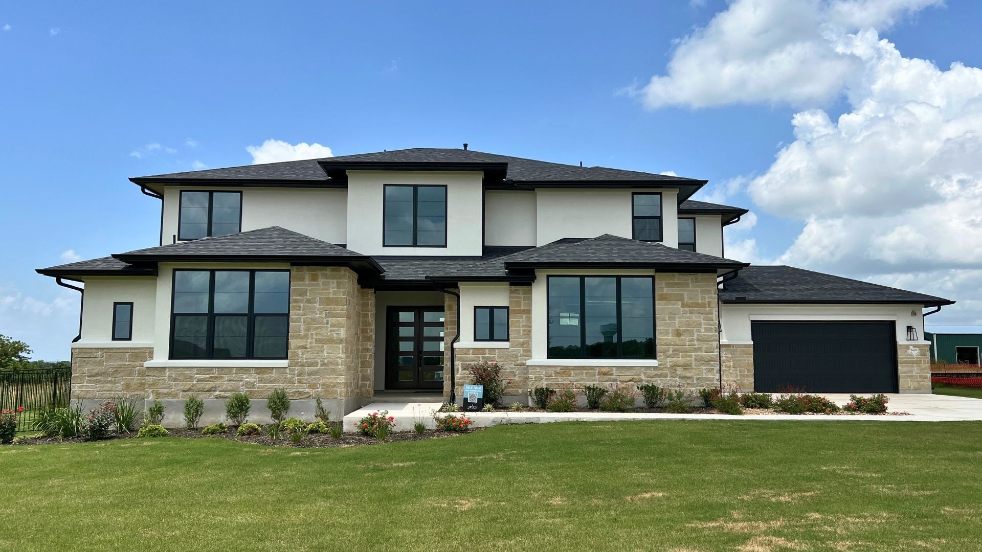 Luxury new construction home exterior in Hilltop Ranch, an acre-lot community in Leander Texas