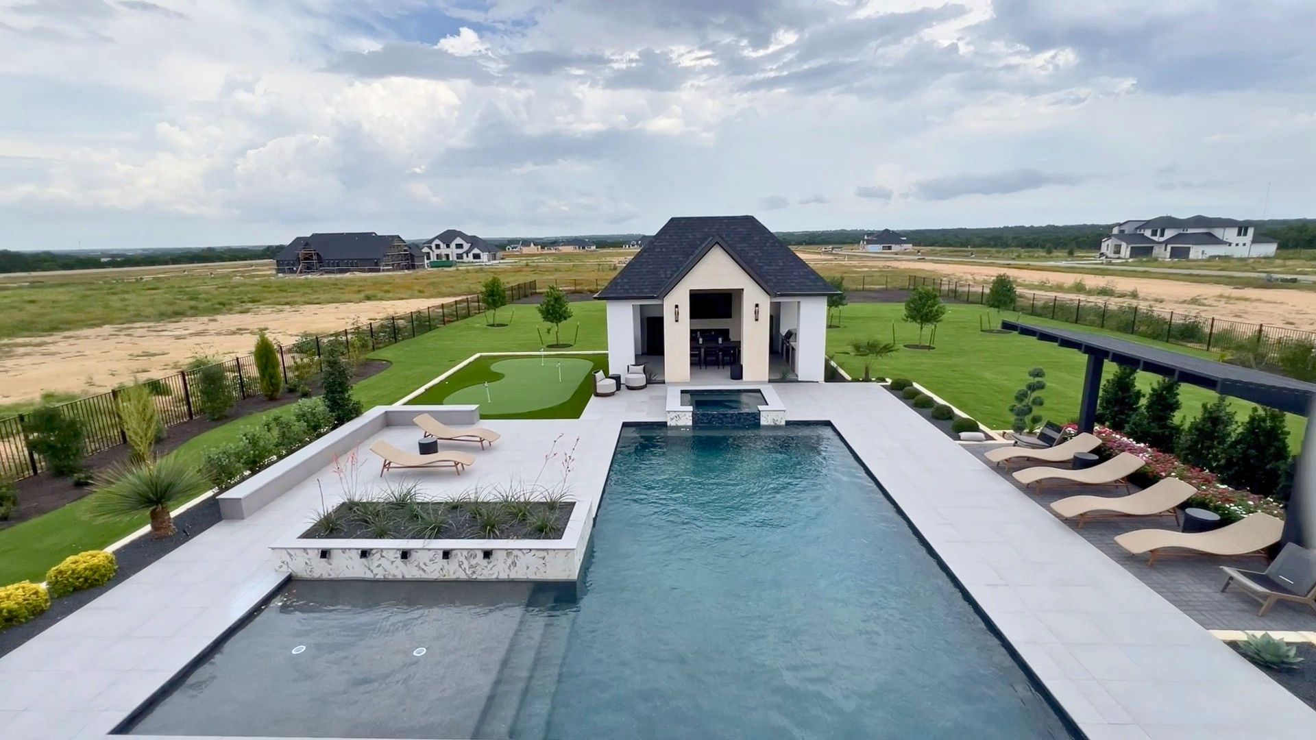 Resort-style pool, detached casita, and putting green at the Drees McKennan model home in Hilltop Ranch, Leander, Texas