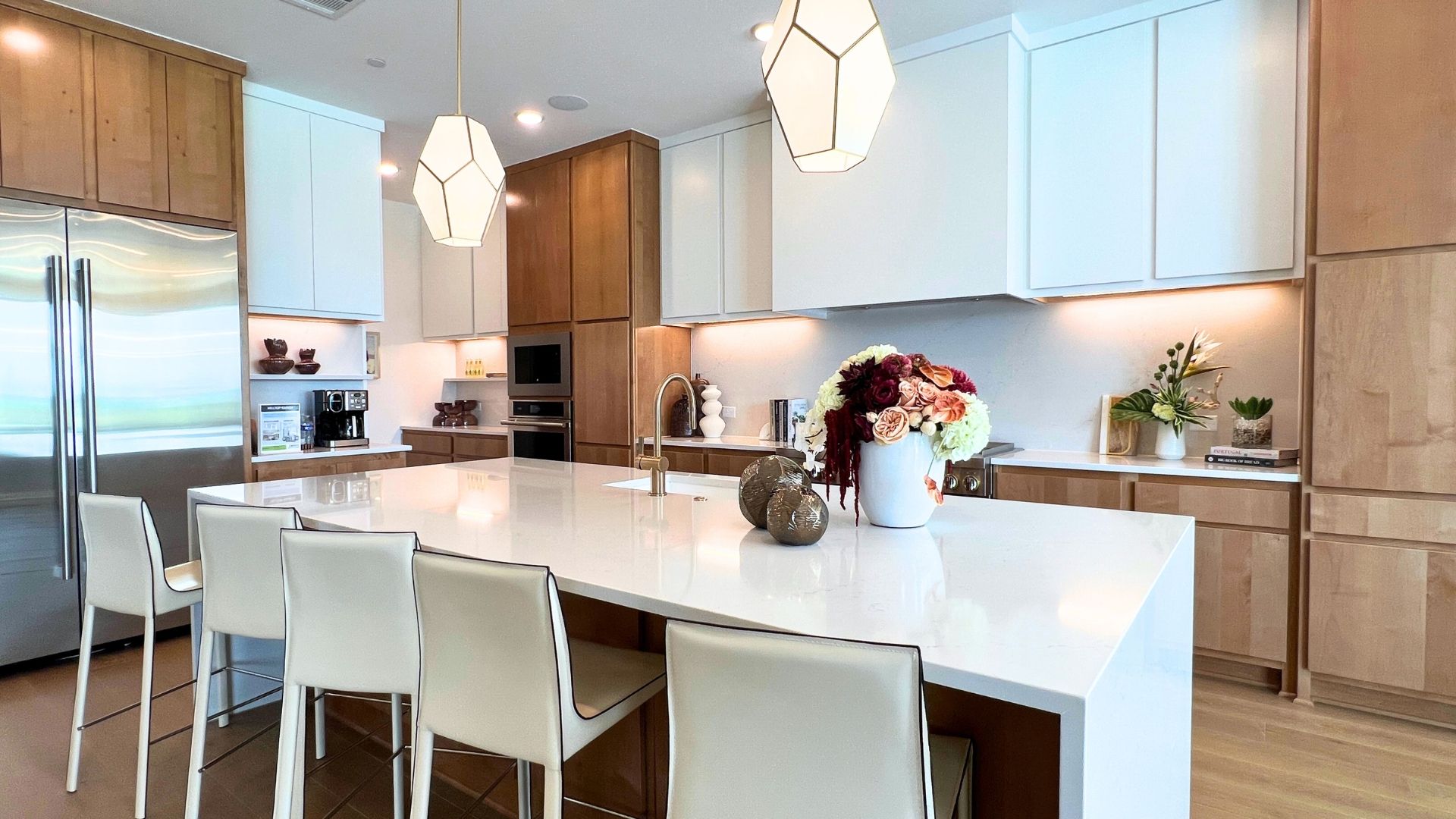 Luxury kitchen with oversized island and custom cabinetry in the Drees McKennan model home at Hilltop Ranch