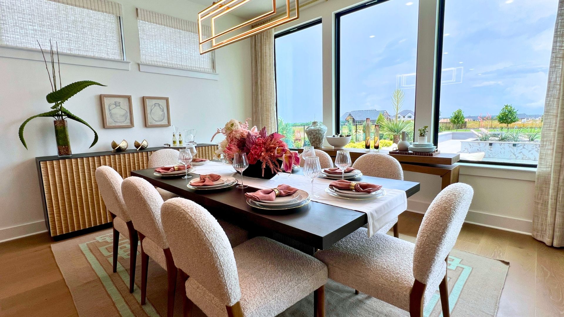 Dining room with large picture windows in the Drees McKennan model home at Hilltop Ranch in Leander, Texas