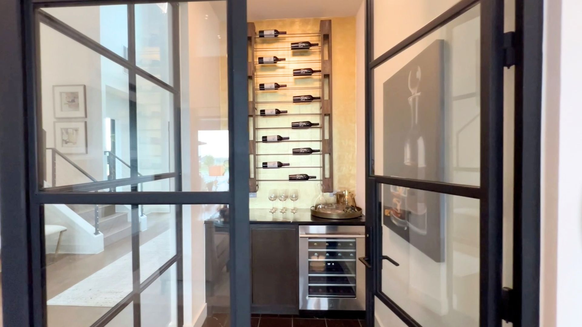 Glass-enclosed wine room in the Drees McKennan model home at Hilltop Ranch in Leander, Texas