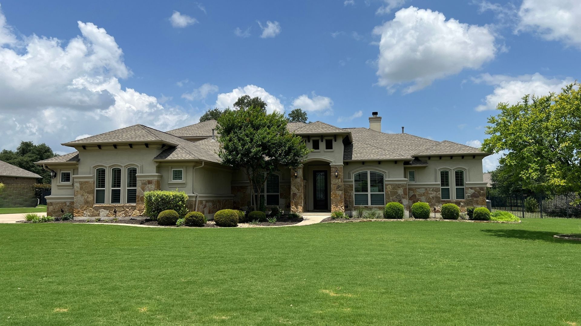 Greatwood neighborhood home with developed landscaping and established character in Leander, Texas