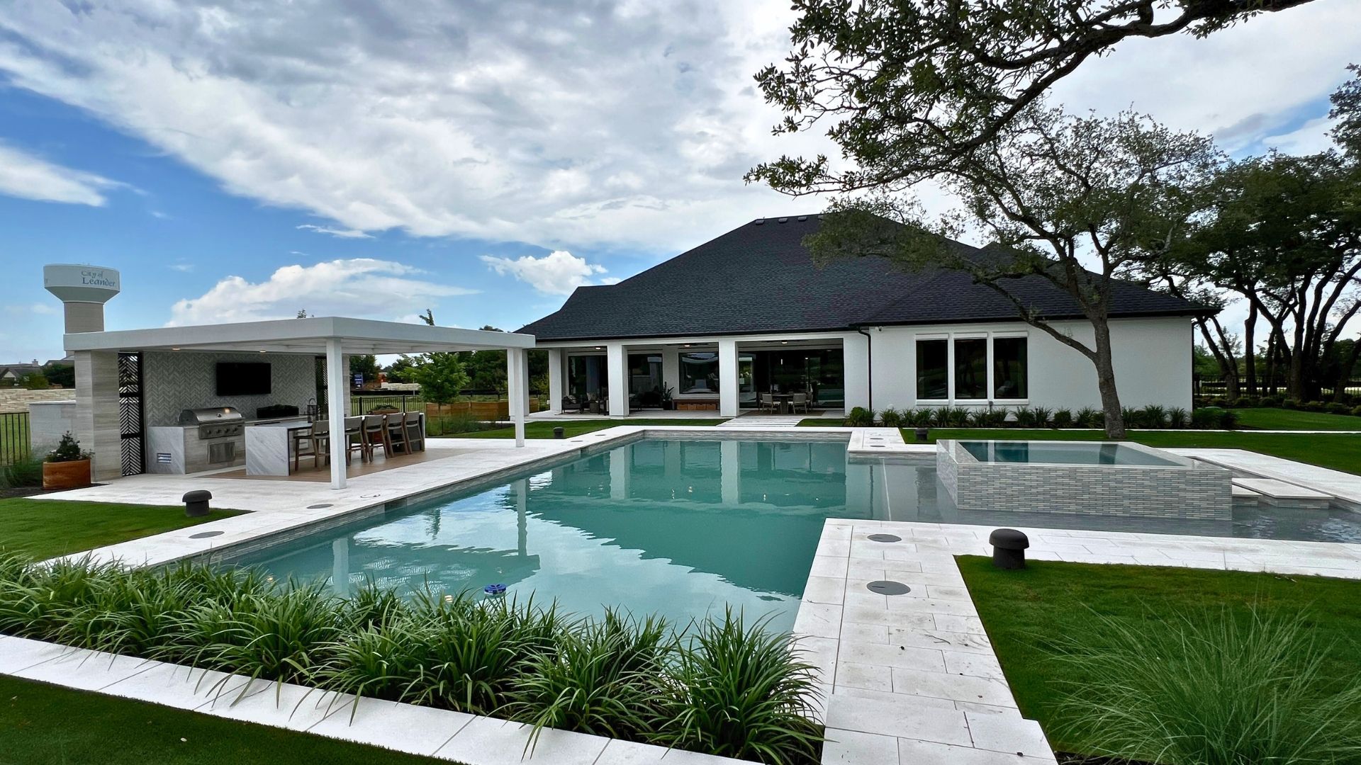 Resort-style pool and outdoor entertaining space at the Bell Springs model home in Woodland Estates, Leander, Texas