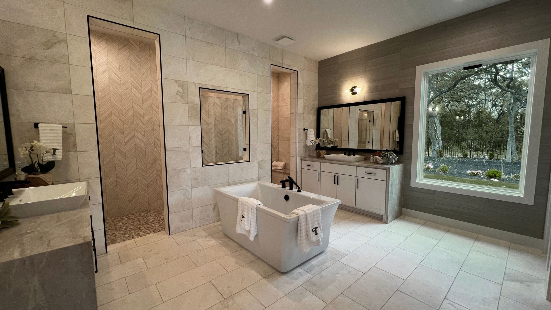 Luxury primary bathroom with soaking tub and walk-in shower in the Bell Springs model home in Leander, Texas