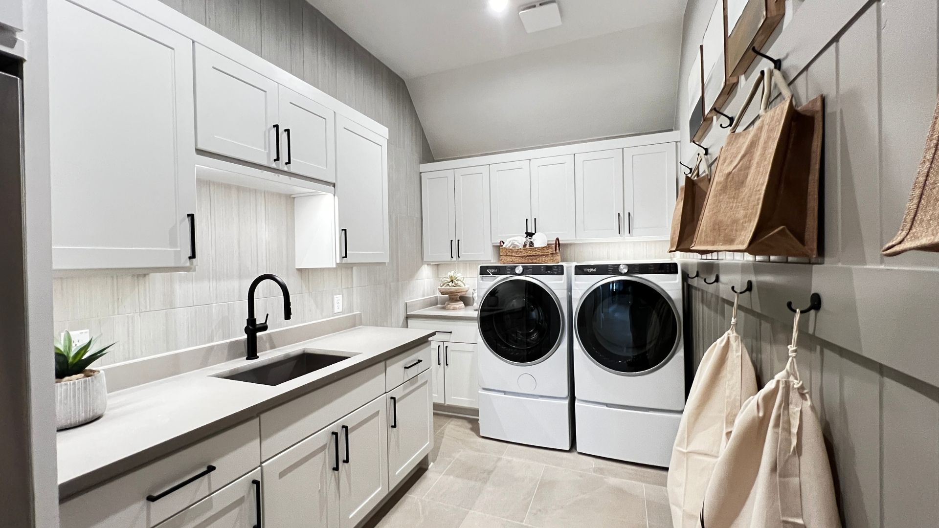 Luxury laundry room with custom cabinetry in the Bell Springs model home, Leander, Texas