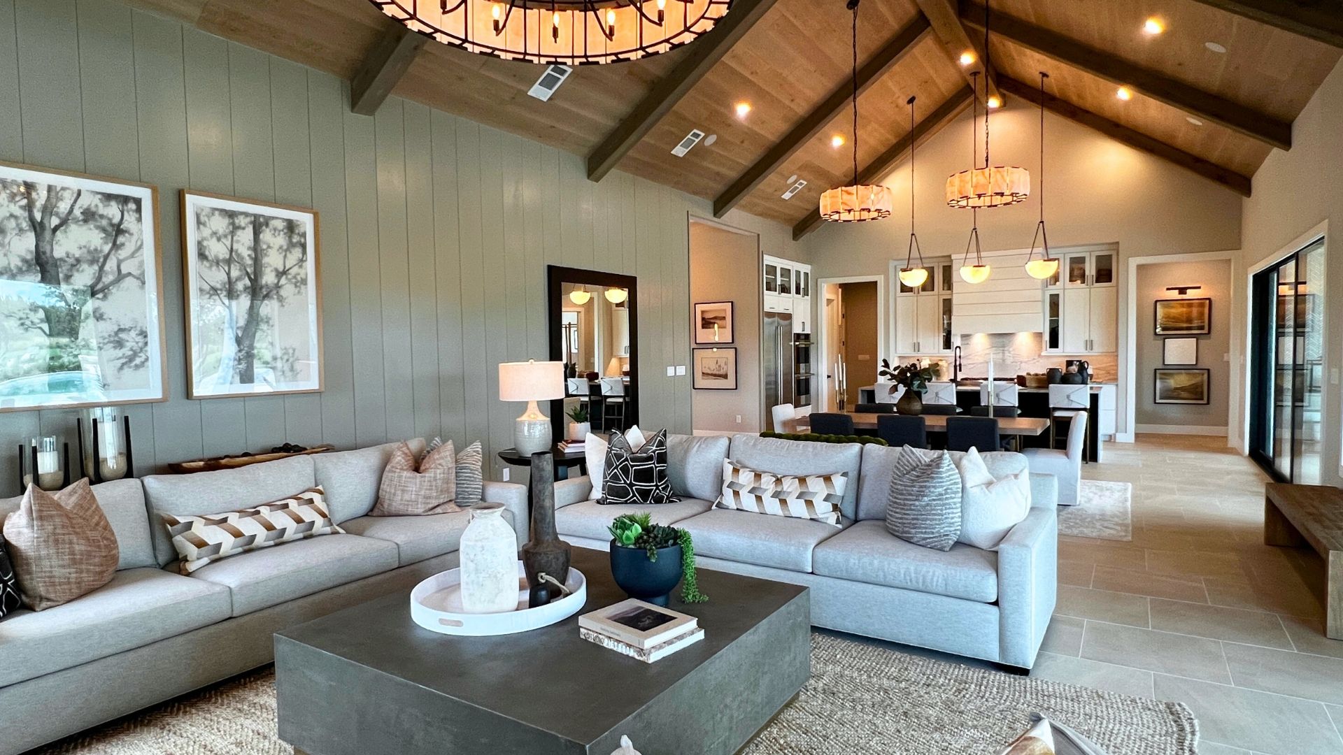 Luxury open-concept living room, dining room, and kitchen with cathedral ceiling in the Toll Brothers Bell Springs model home
