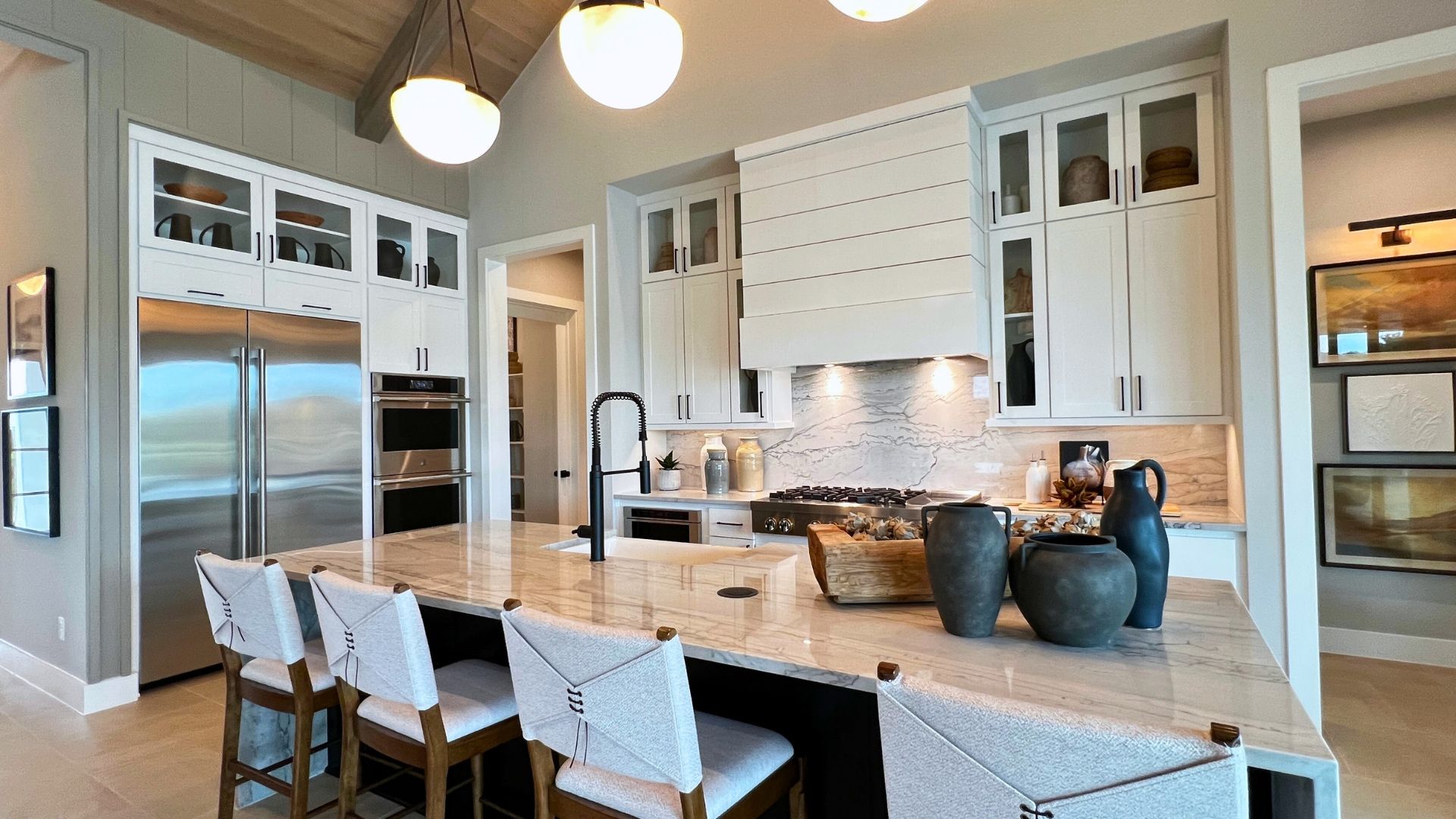 Luxury kitchen with oversized island in the Toll Brothers Bell Springs model home at Woodland Estates