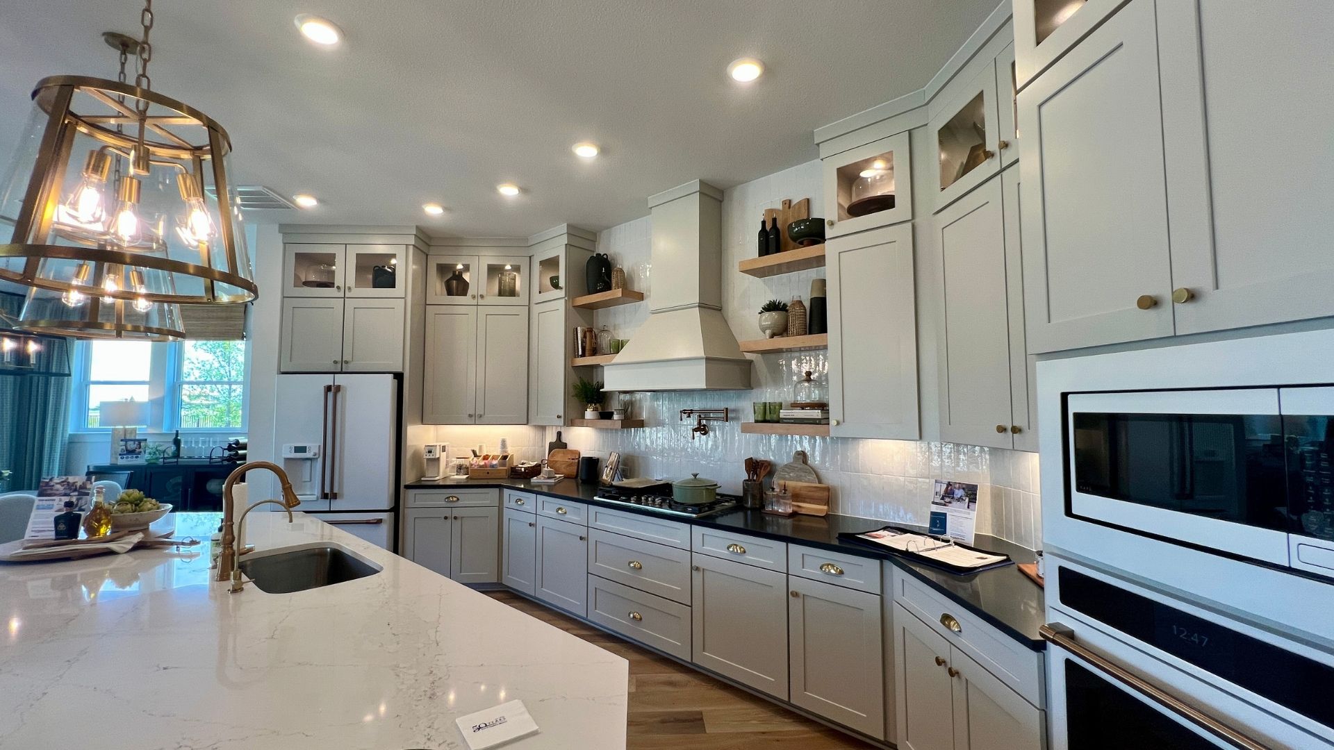 Gourmet kitchen with luxury finishes inside the David Weekley Monterey model home at Leander Estates in Leander Texas