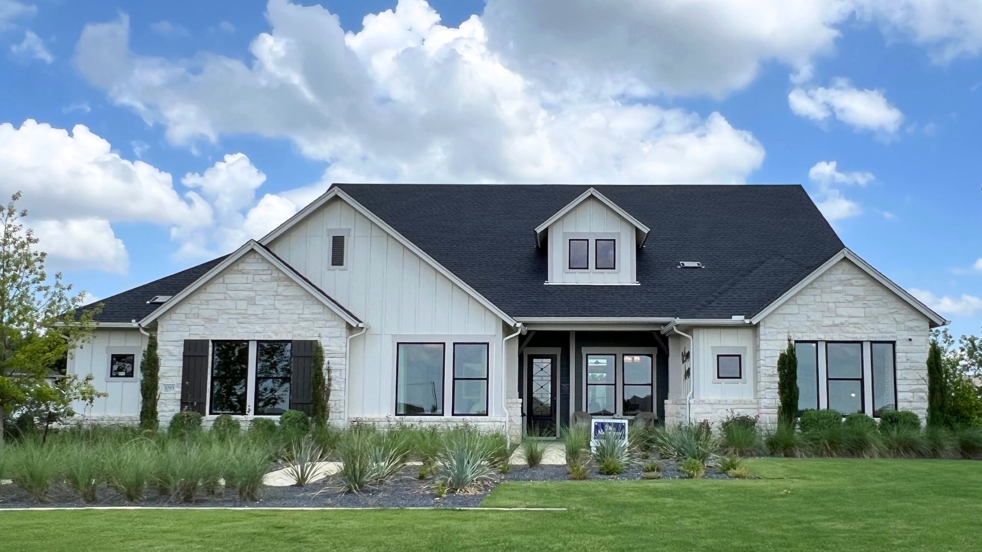 David Weekley Monterey model home with modern farmhouse exterior at Leander Estates in Leander Texas