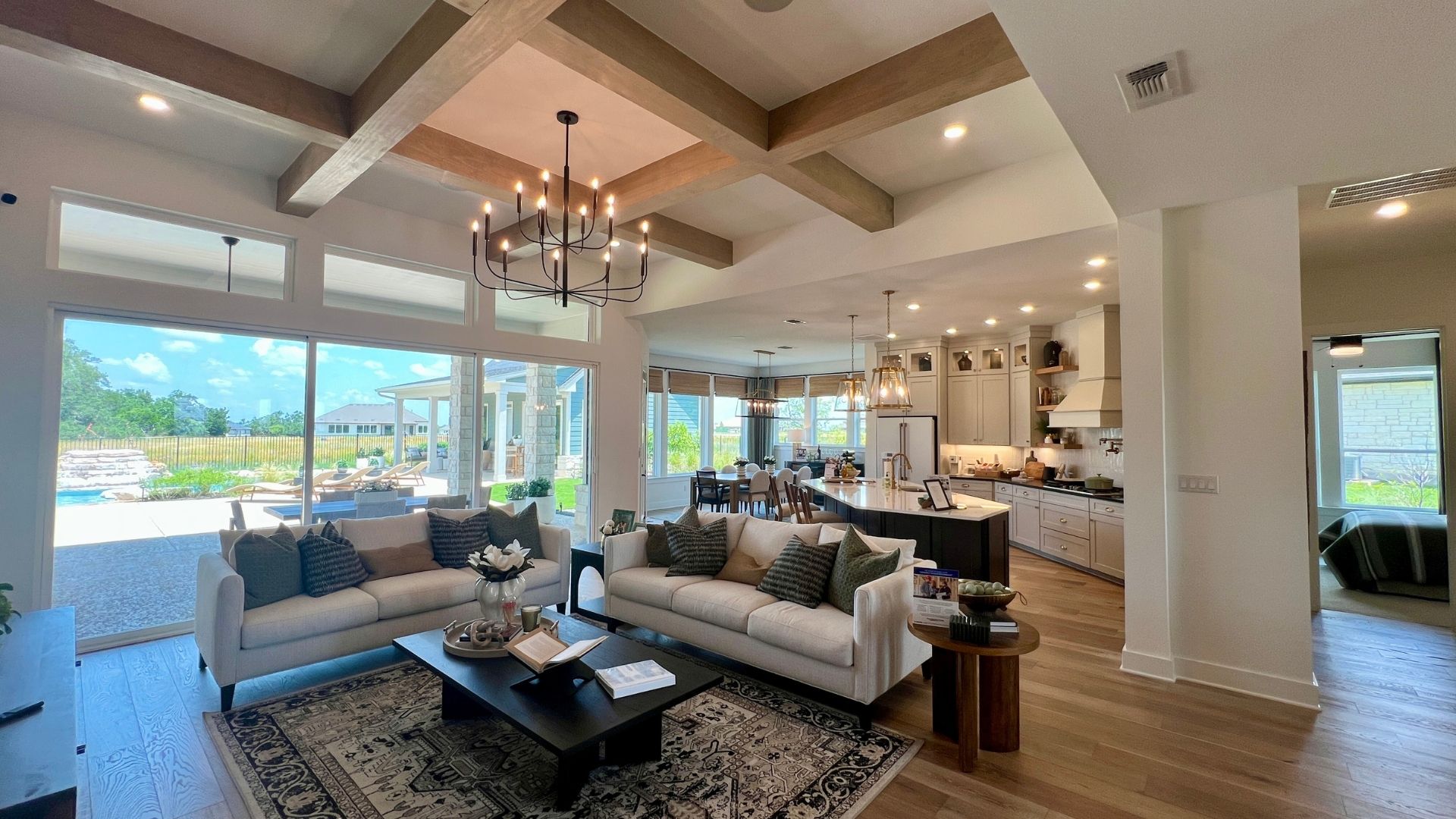 Open concept living room and kitchen inside the David Weekley Monterey model home at Leander Estates in Leander Texas