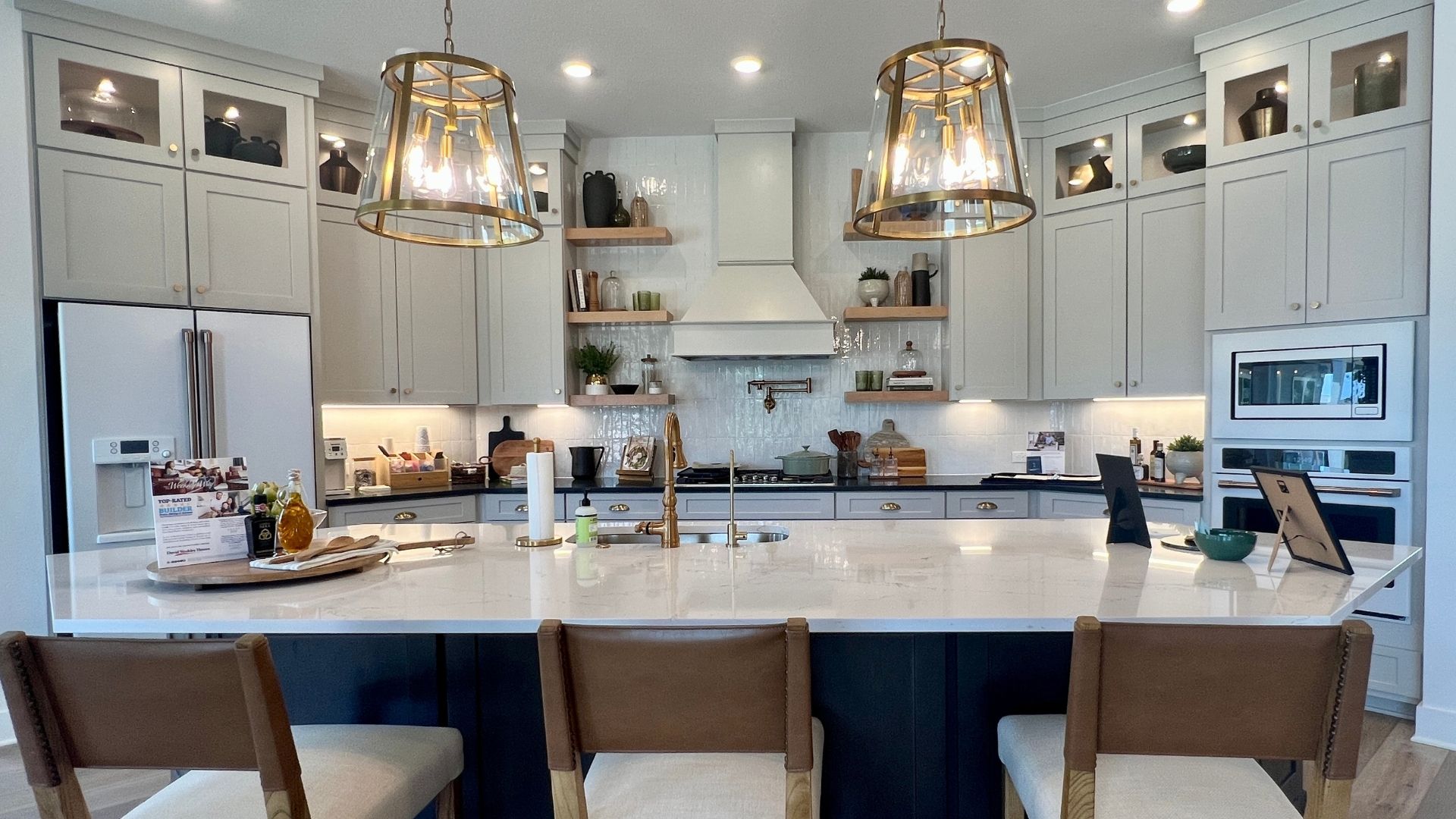 Kitchen island with breakfast bar inside the David Weekley Monterey model home at Leander Estates in Leander Texas