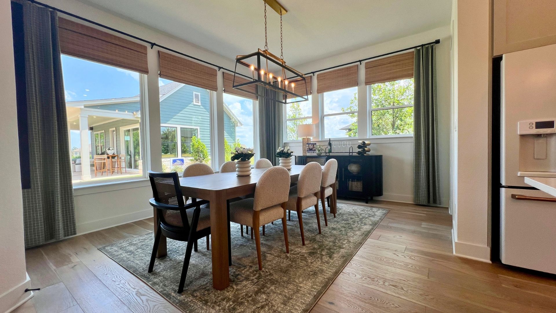 Open concept dining area and kitchen inside the David Weekley Monterey model home at Leander Estates in Leander Texas