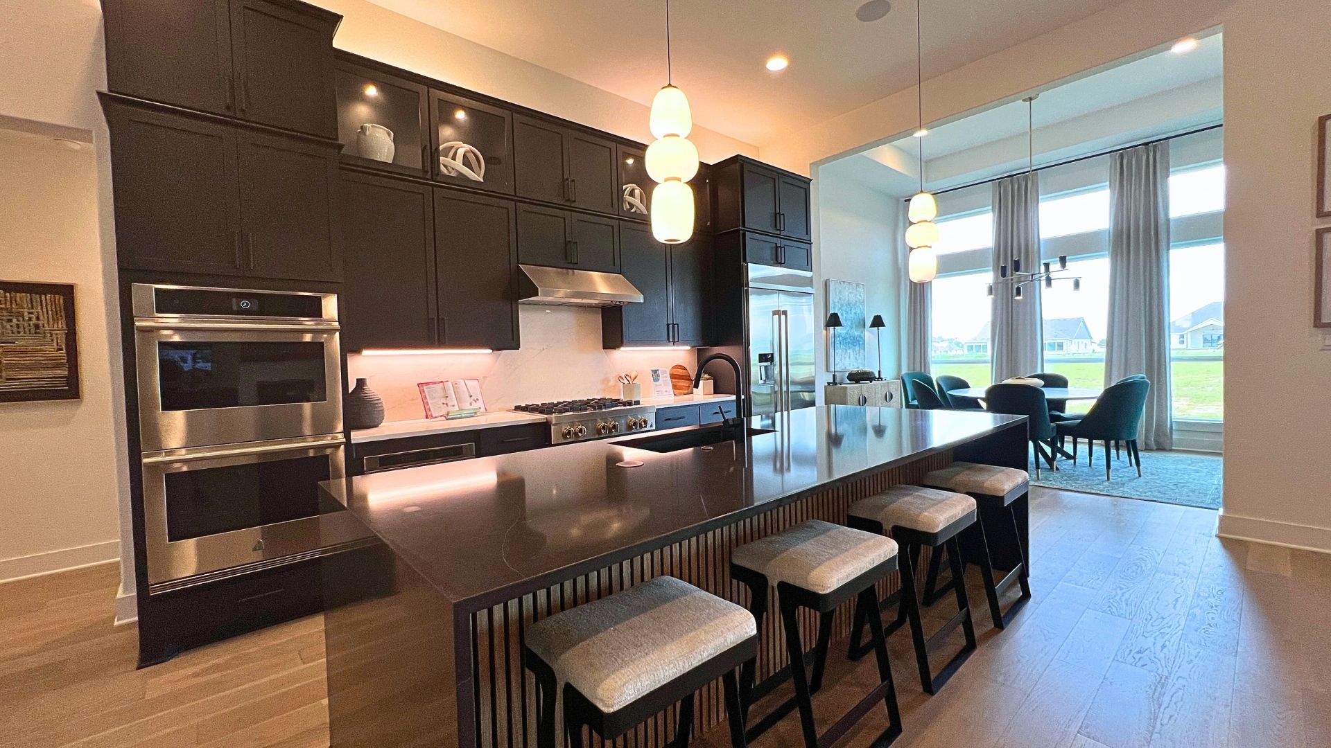 Designer kitchen with oversized island in the Giddens Kerrville model home at Leander Estates in Leander Texas