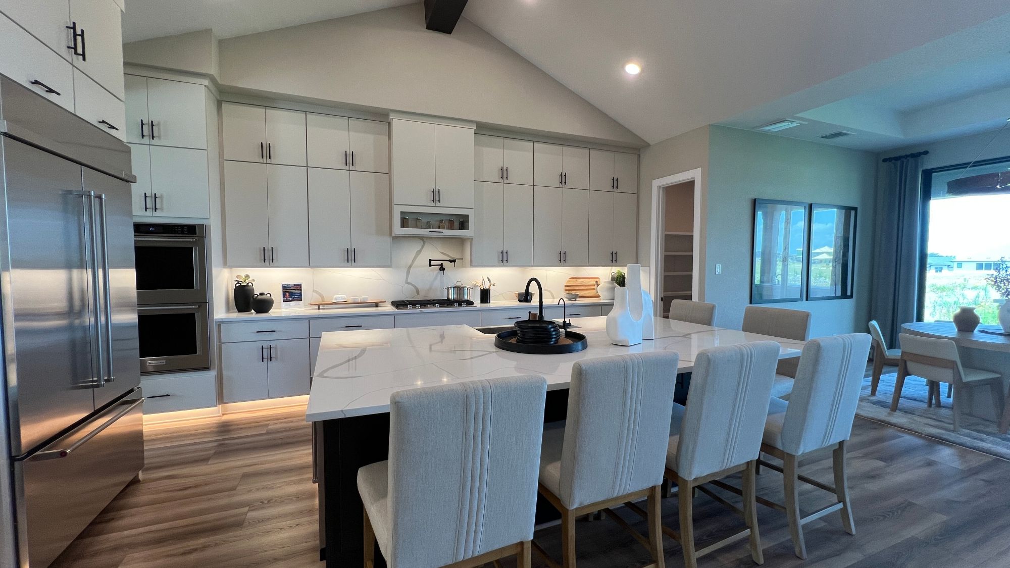 Luxury kitchen with island seating in the Scott Felder Bulverde model home at Leander Estates in Leander Texas