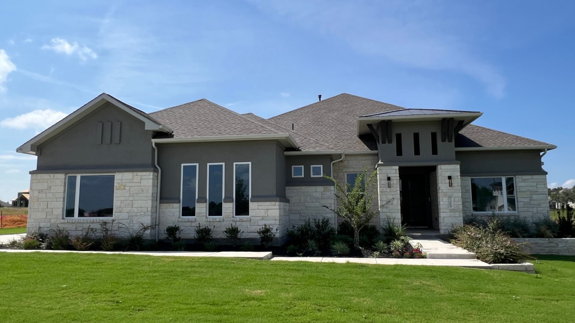 Luxury single-story home in Leander Estates with modern Hill Country architecture and a one-acre homesite in Leander Texas