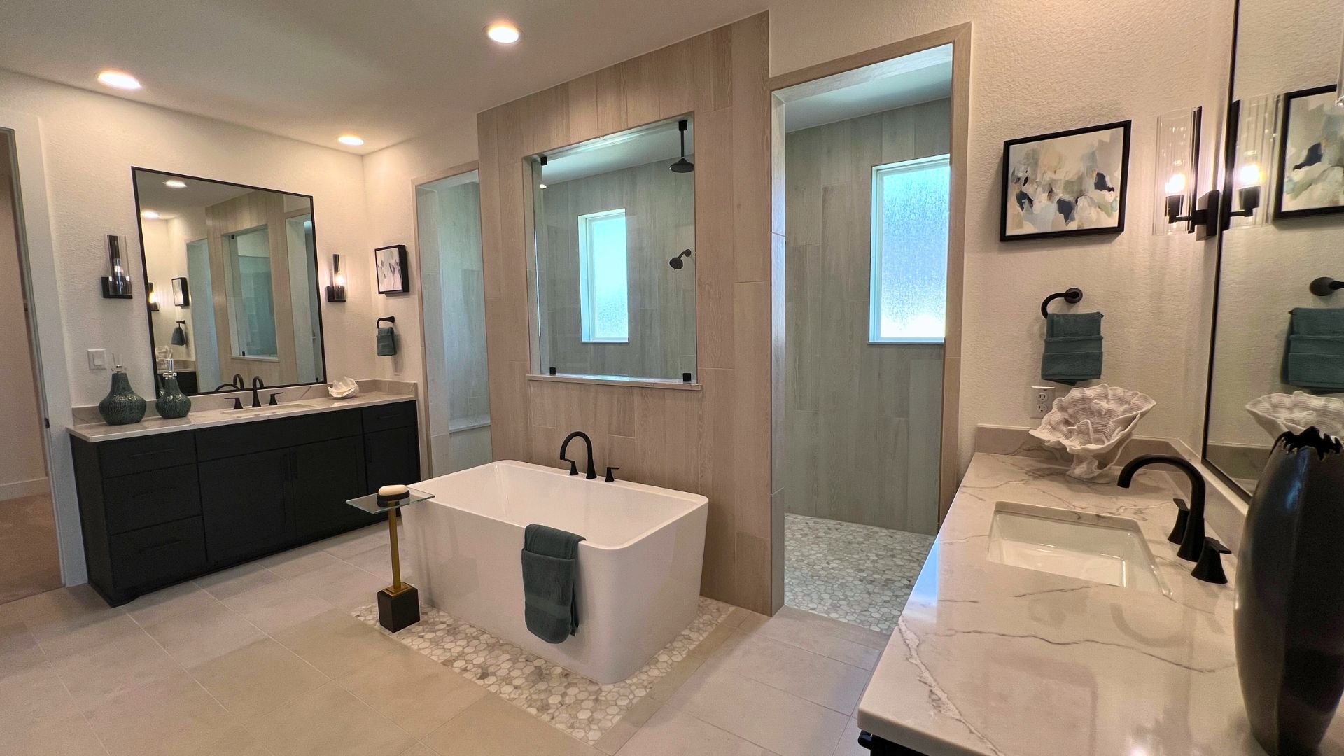 Luxury primary bathroom with freestanding soaking tub and walk-in shower in the Giddens Kerrville model home at Leander Estates in Leander Texas