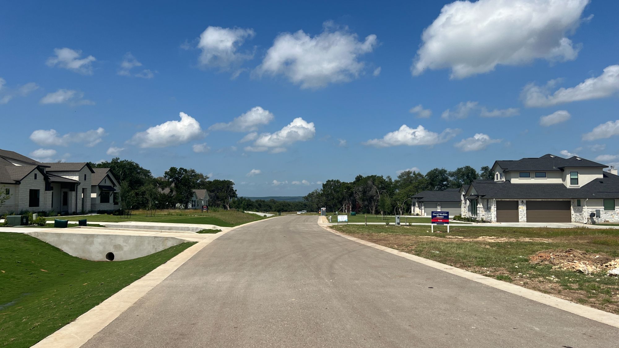 Wide streets and one-acre homesites in Leander Estates, a luxury new construction community in Leander Texas