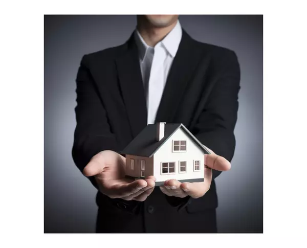 allstarleb_realtor_holding_house_in_his_hand_d23028f9-1806-4e7a-9e35-cc46d557c4e9-1