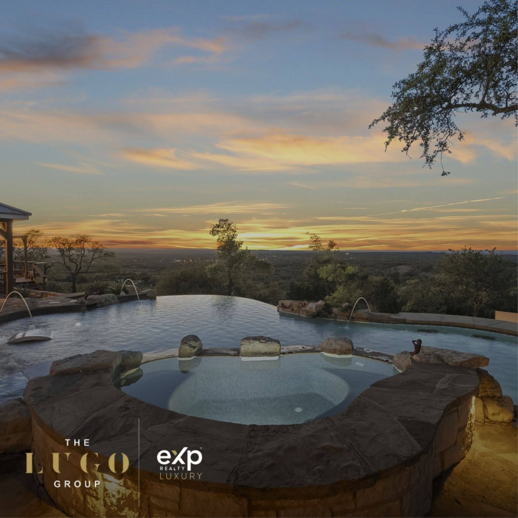San Antonio luxury home infinity pool with Hill Country views at sunset, featuring The Lugo Group branding.
