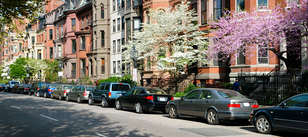 cars parked on street in boston to represent parking hassle