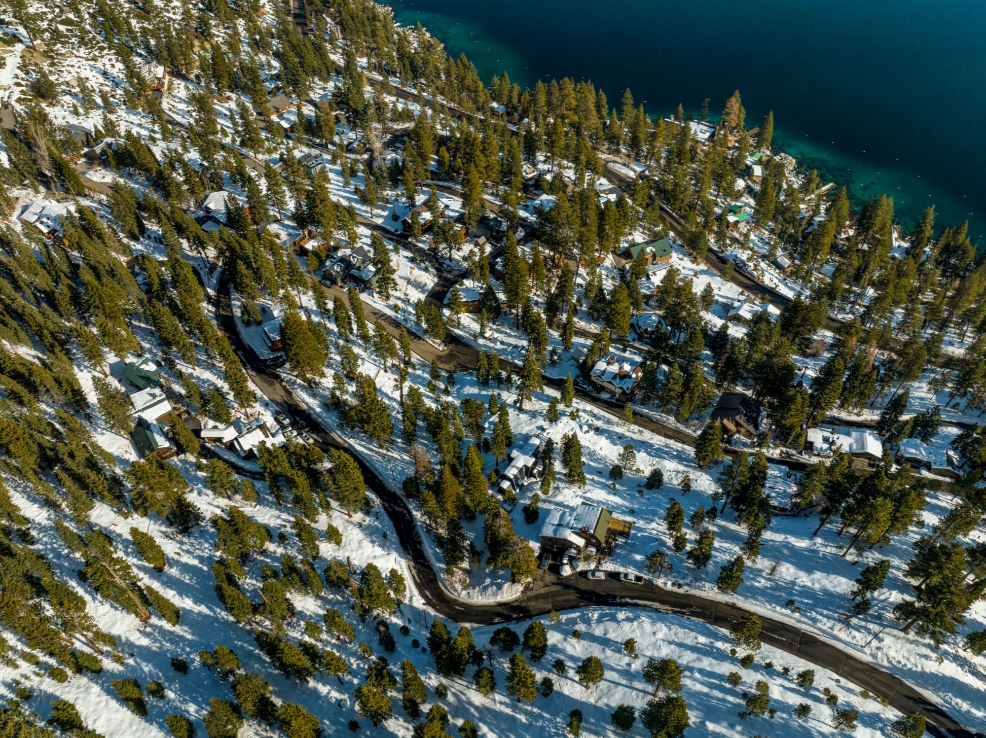 Snow berm at the entrance to a luxury Lake Tahoe driveway after road plowing